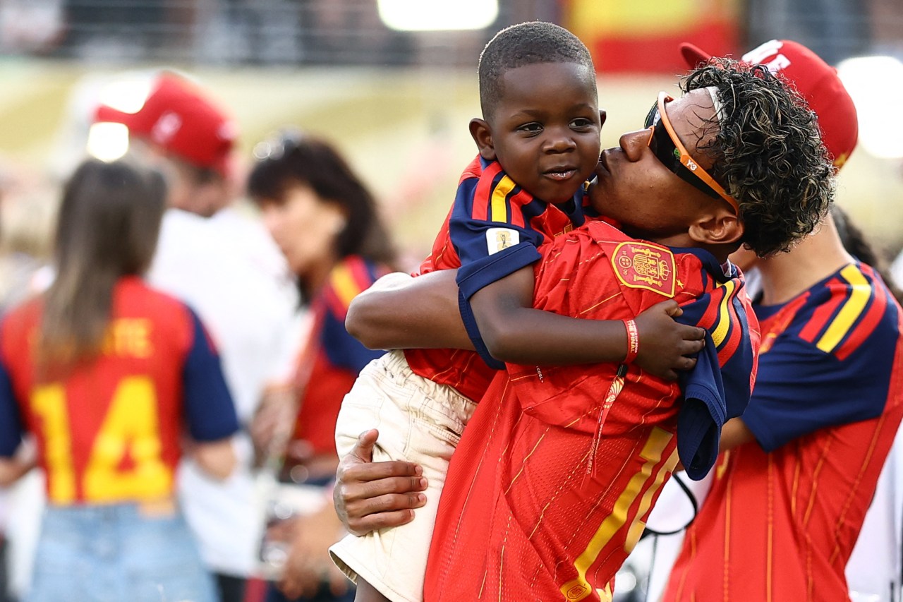 Lamine Yamal hugging his brother Keyne on the field after Spain wins the 2026 FIFA World Cup final against Argentina