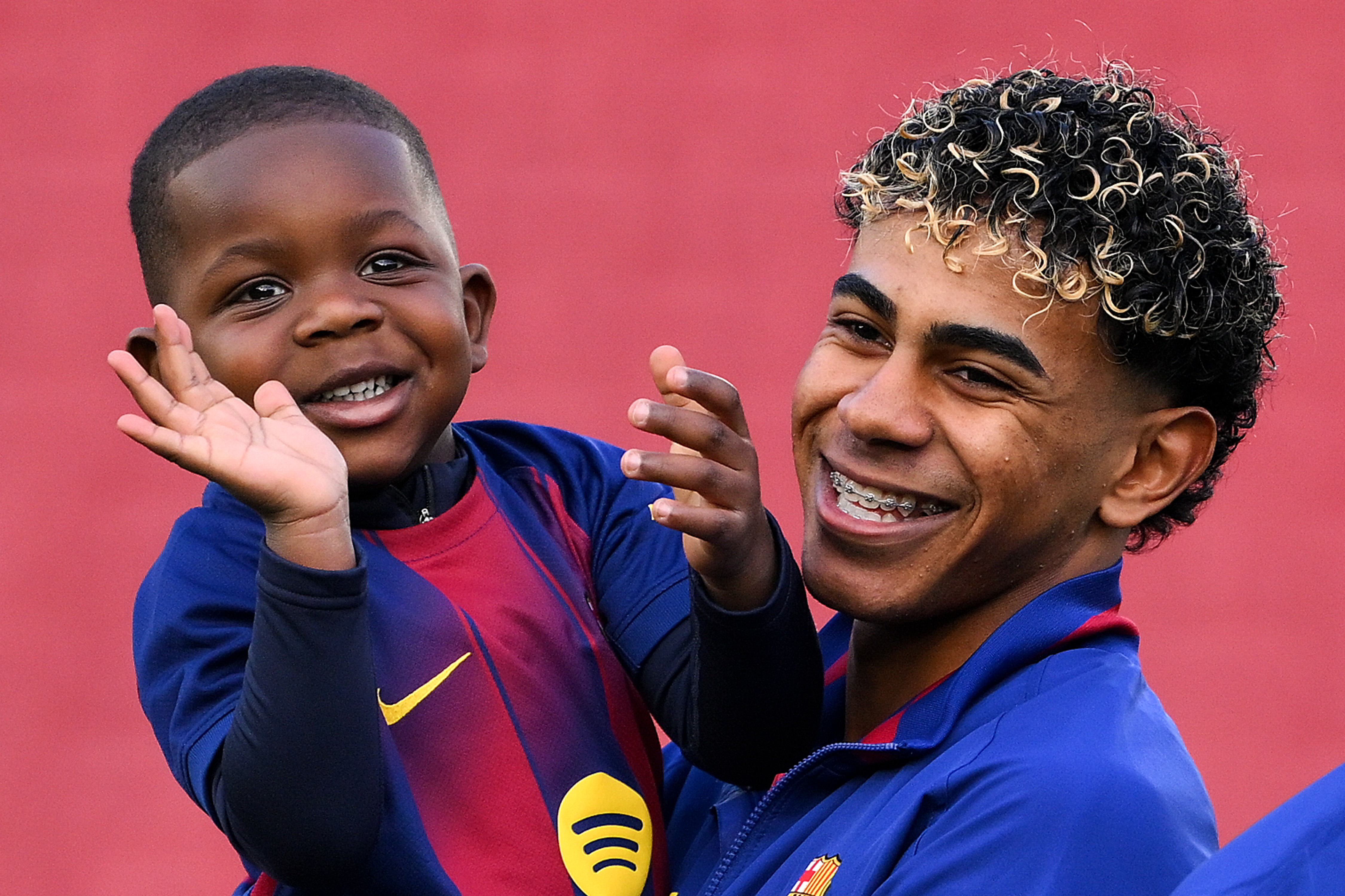 Click to open the image gallery Lamine Yamal crouching on the pitch interacting with his younger brother Keyne Yamal at Spotify Camp Nou