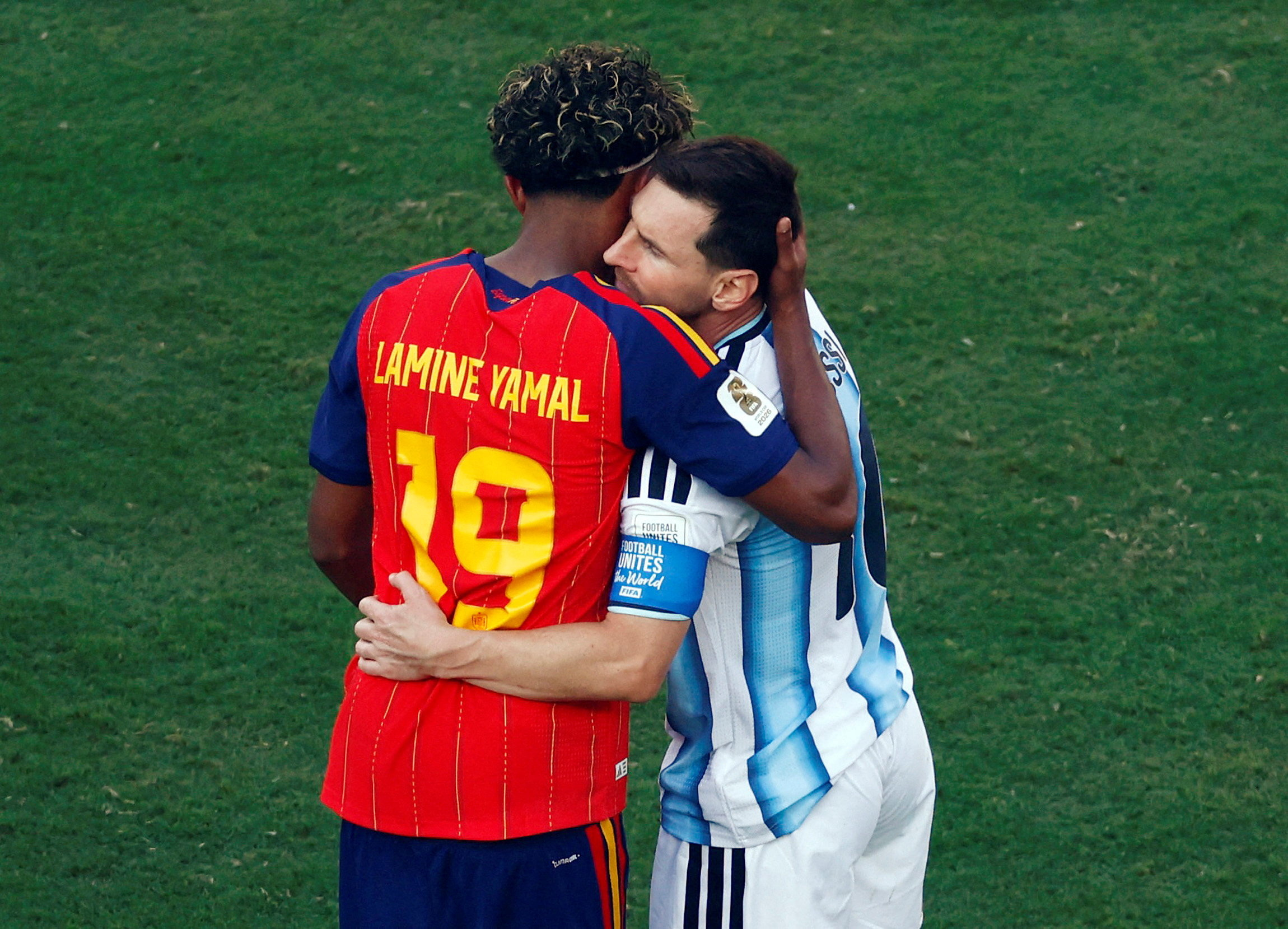 Lamine Yamal hugging Lionel Messi on the field after the 2026 FIFA World Cup Final between Spain and Argentina
