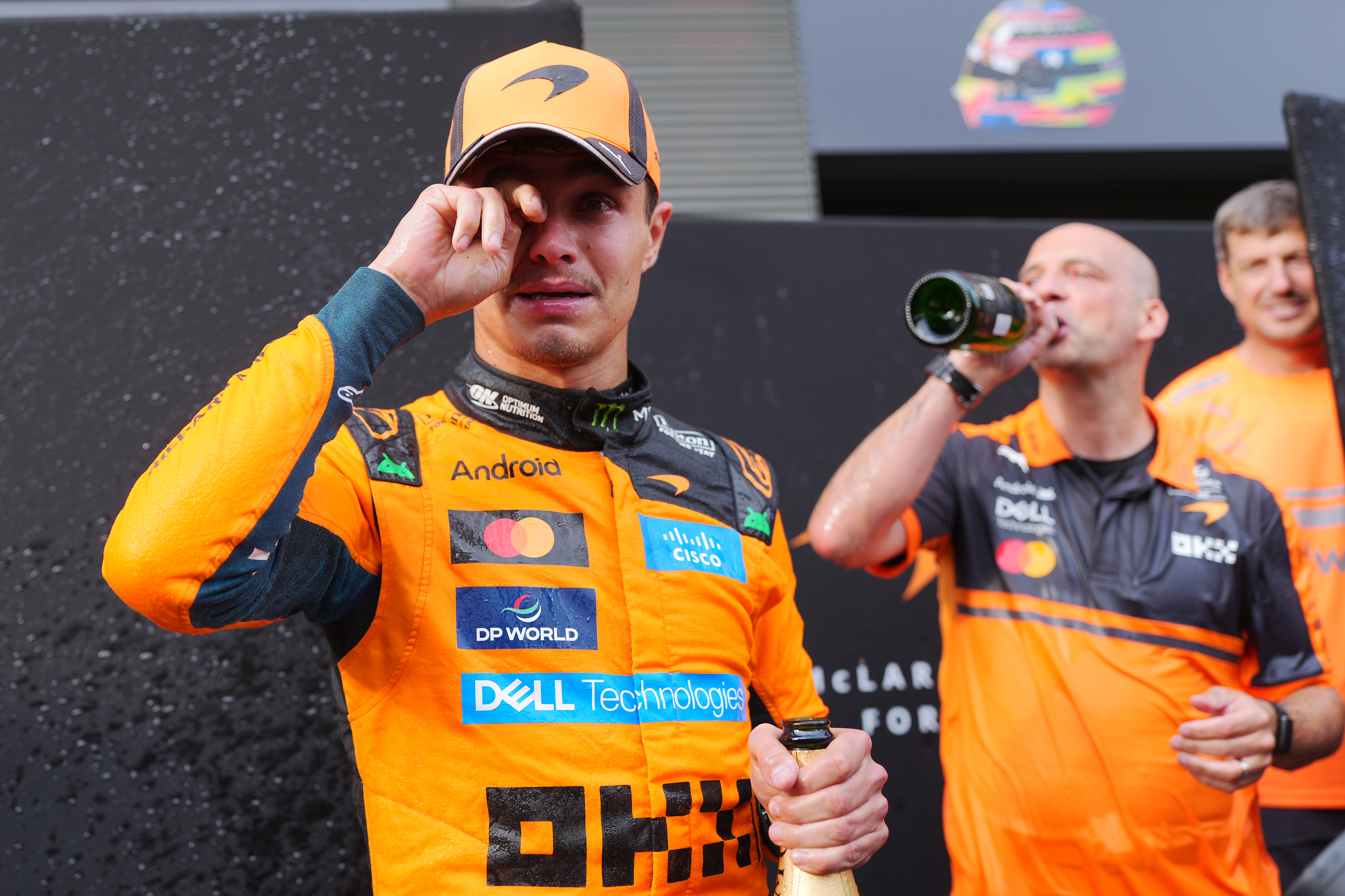 Lando Norris celebrating with his McLaren team after winning the F1 Grand Prix of Hungary at Hungaroring