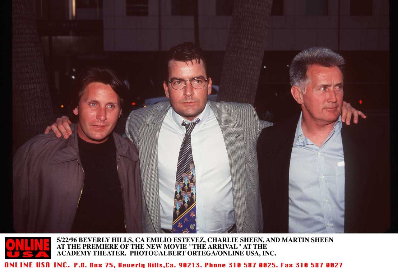 Emilio Estevez, Charlie Sheen, and Martin Sheen standing together at a movie premiere in Beverly Hills in 1996