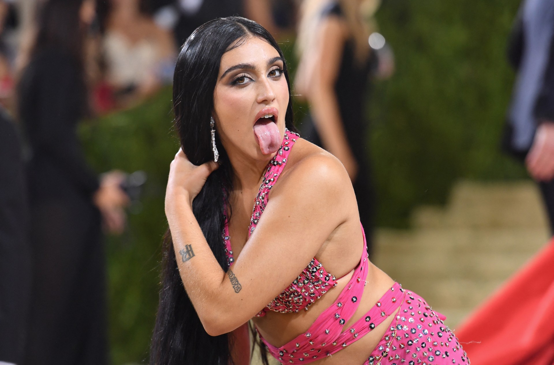 Lourdes Leon in a pink embellished crop outfit sticking her tongue out at the 2021 Met Gala red carpet.