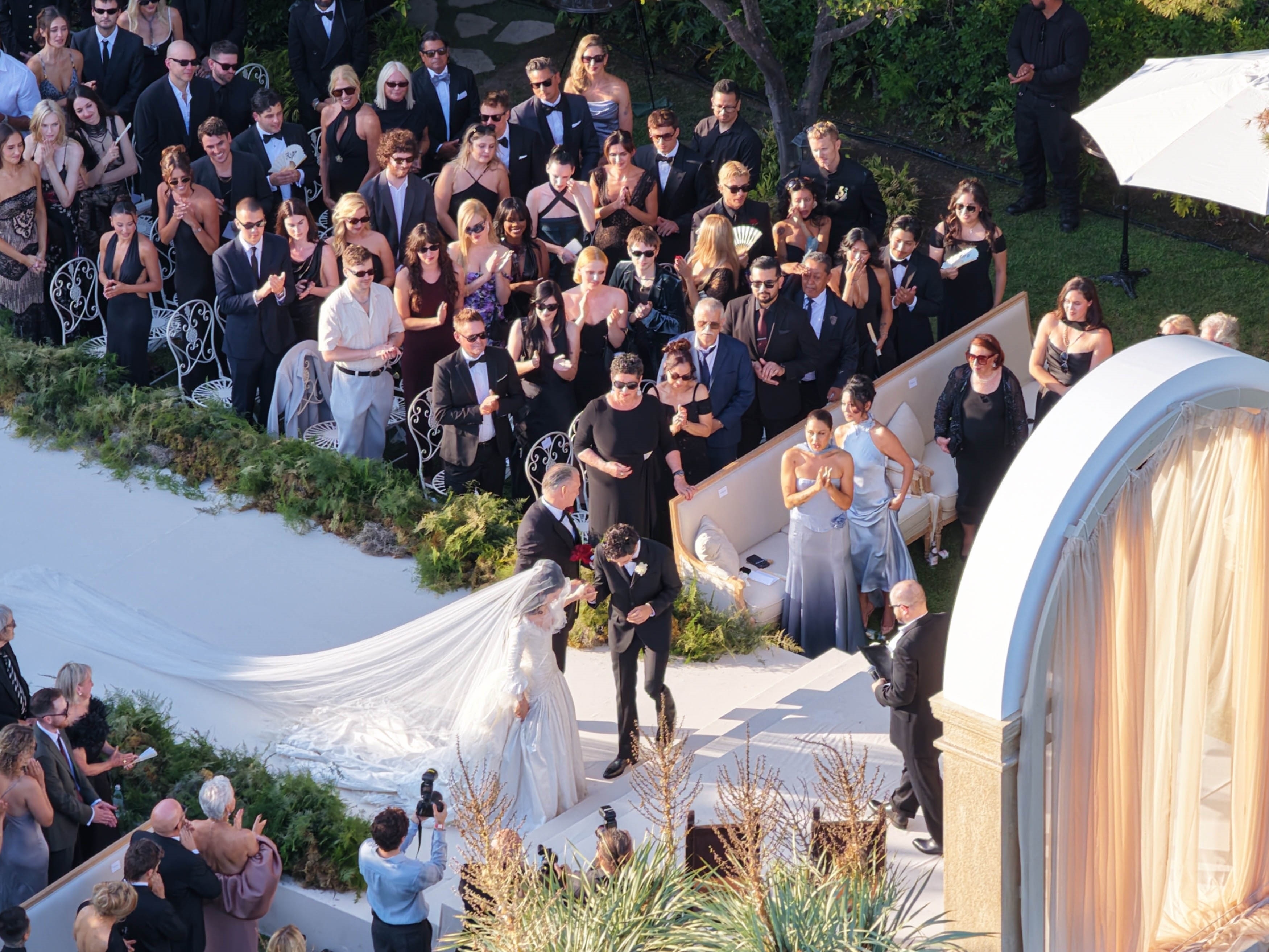 Aerial view of a Hollywood Hills estate decorated for Matty Healy and Gabbriette Bechtel's wedding, with the Hollywood Sign visible in the background.