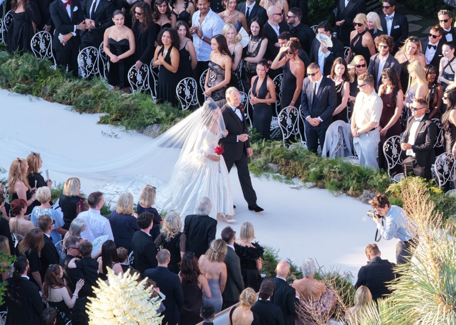 Aerial view of a Hollywood Hills estate decorated for Matty Healy and Gabbriette Bechtel's wedding, with the Hollywood Sign visible in the background