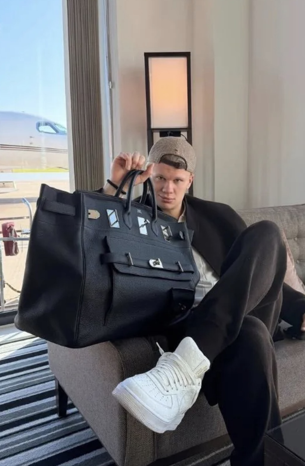 Erling Haaland posing with luxury handbags in an Instagram photo