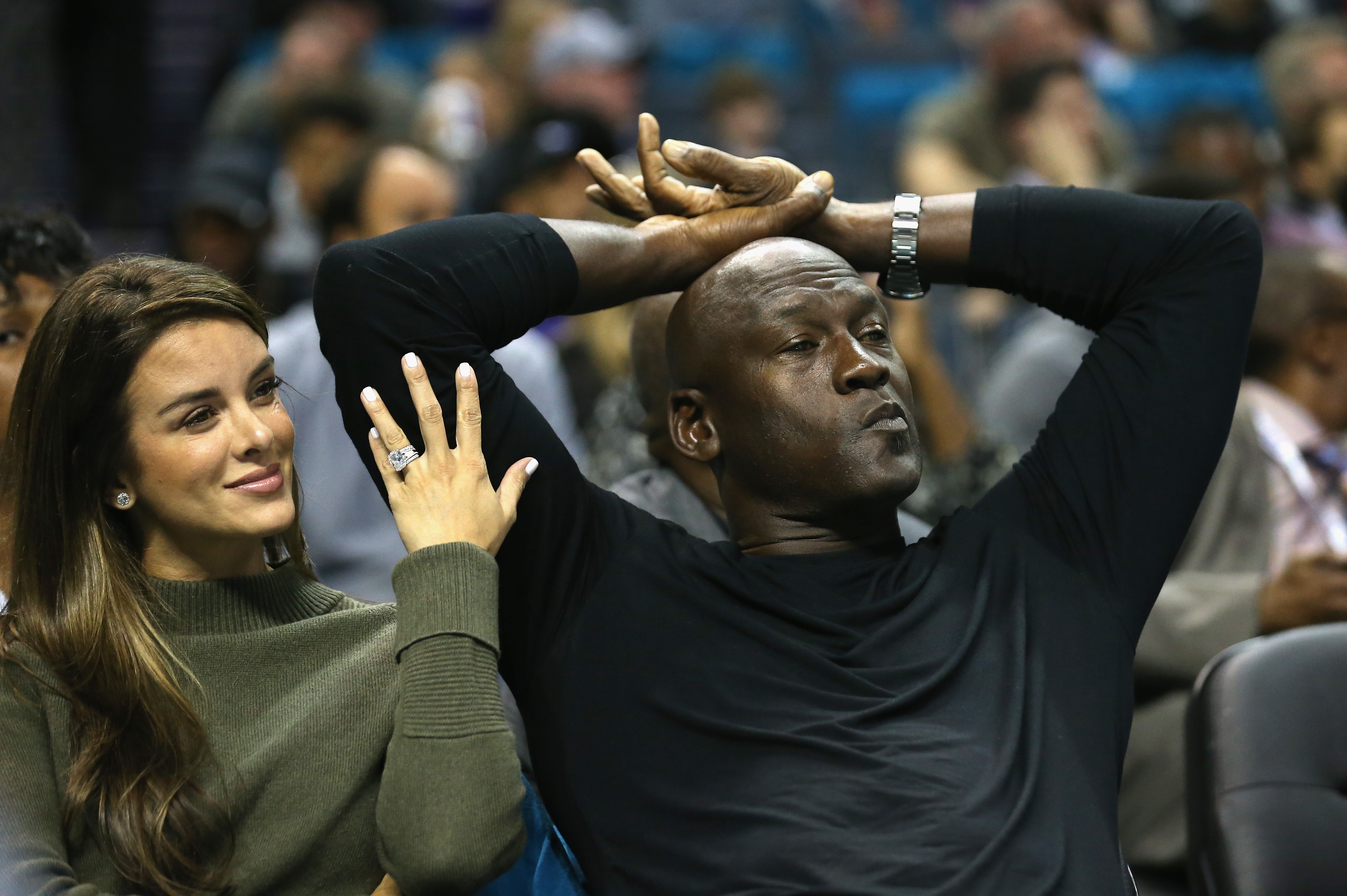 Michael Jordan and Yvette Prieto sitting courtside at a Charlotte Hornets game in November 2015