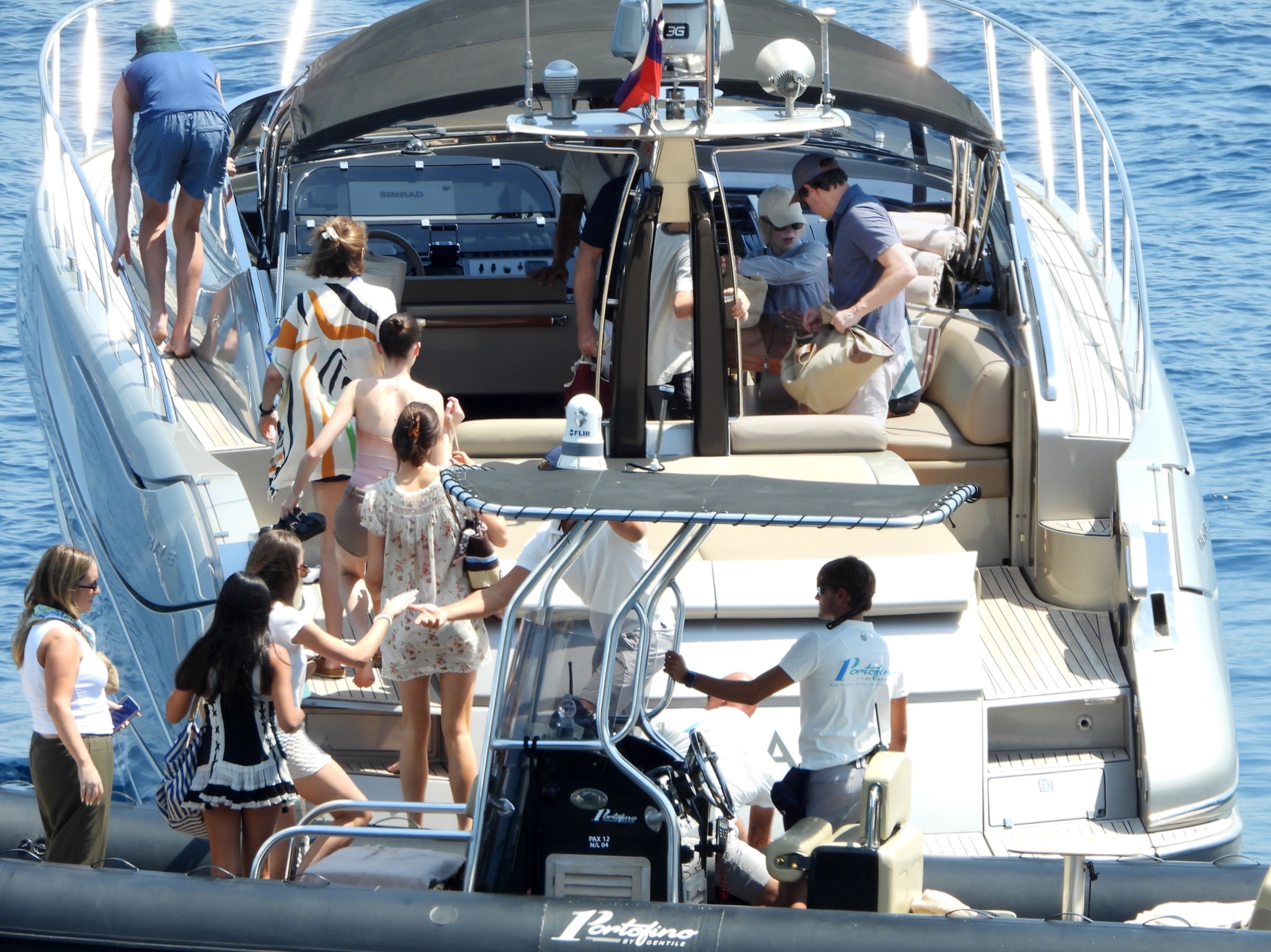 Nicole Kidman in a striped shirt and denim shorts boarding a boat in Portofino with her family