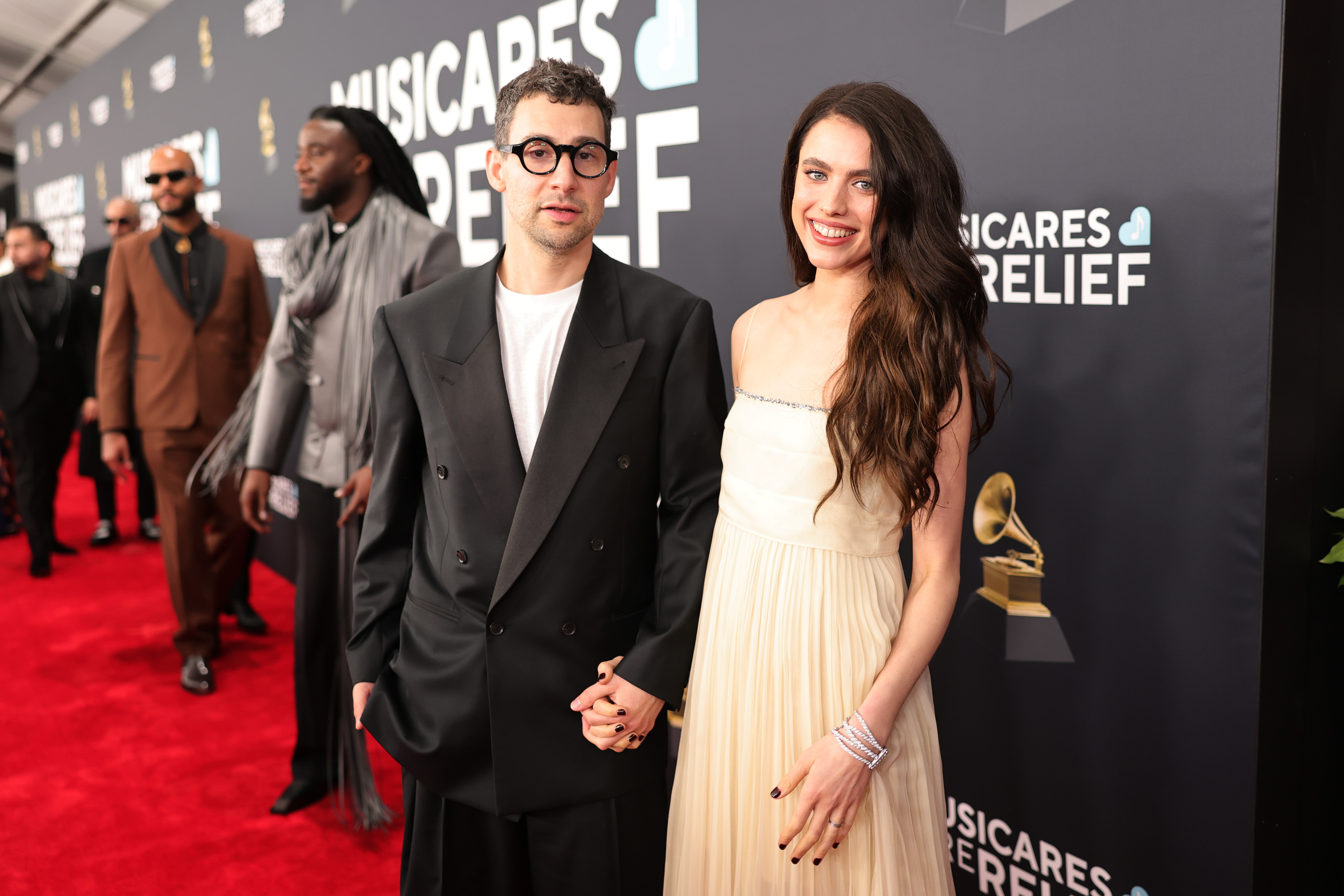 Jack Antonoff and Margaret Qualley standing together on the red carpet at the 67th Annual Grammy Awards