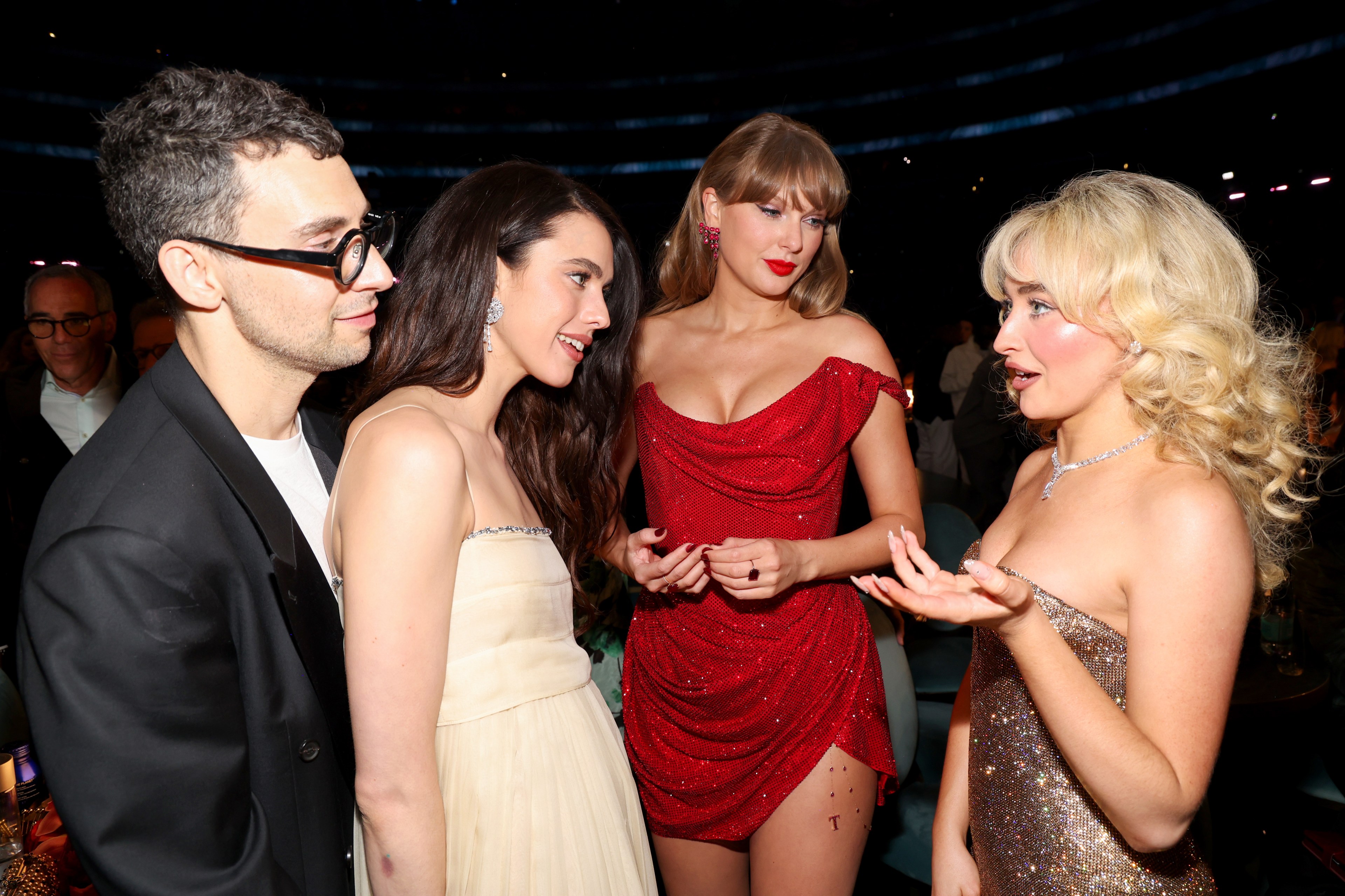 Jack Antonoff, Margaret Qualley, Taylor Swift, and Sabrina Carpenter talking together at the 67th Grammy Awards in Los Angeles.