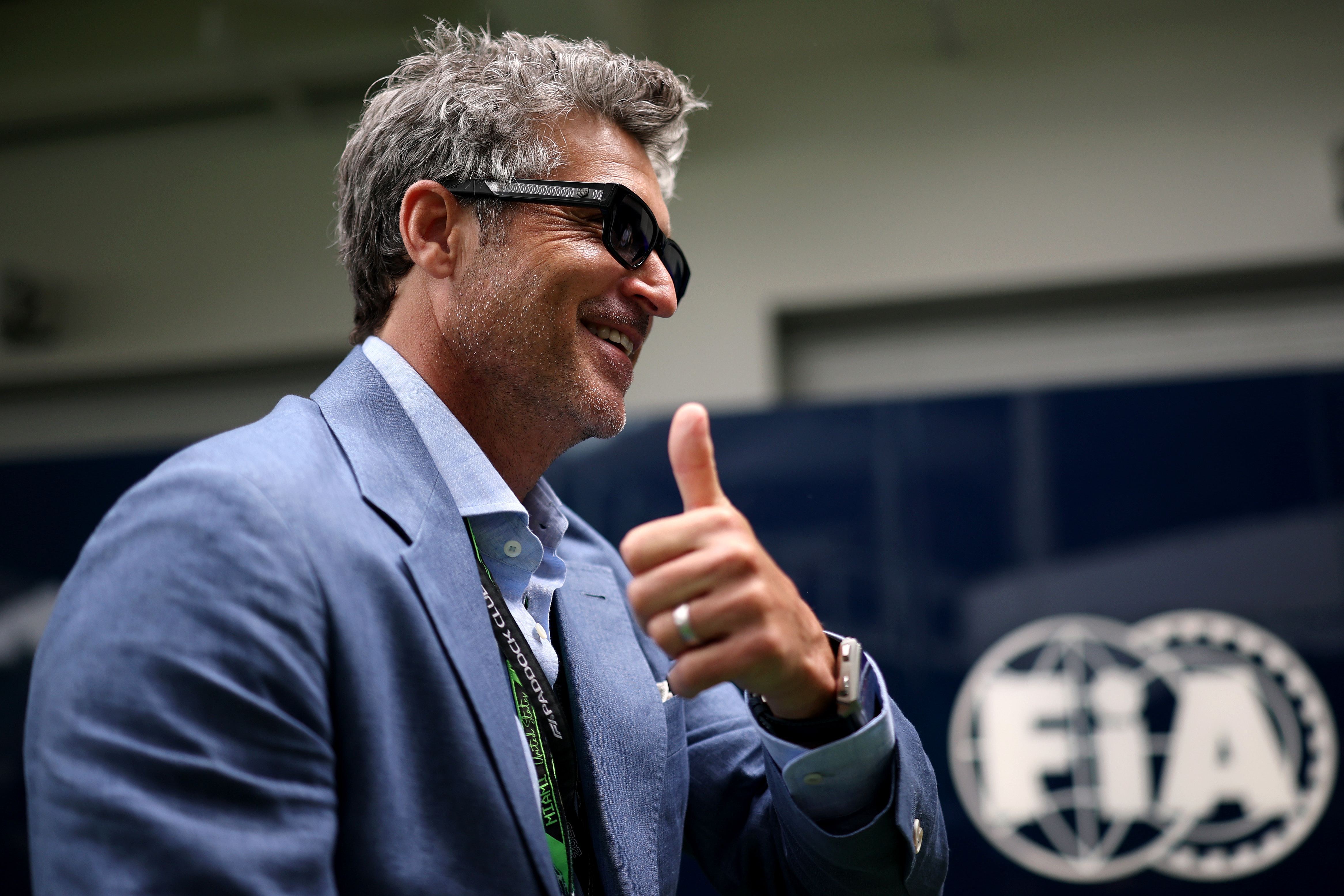Patrick Dempsey standing in the paddock at the Miami International Autodrome at the F1 Grand Prix of Miami