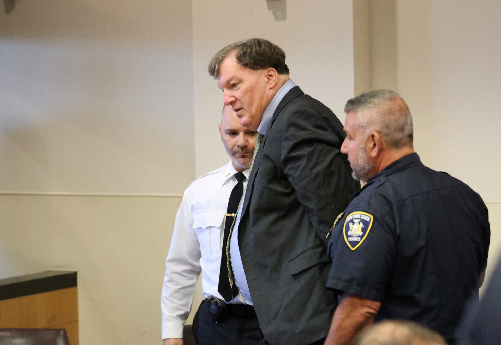 Rex Heuermann being escorted into a courtroom at Suffolk County Court in Riverhead, New York