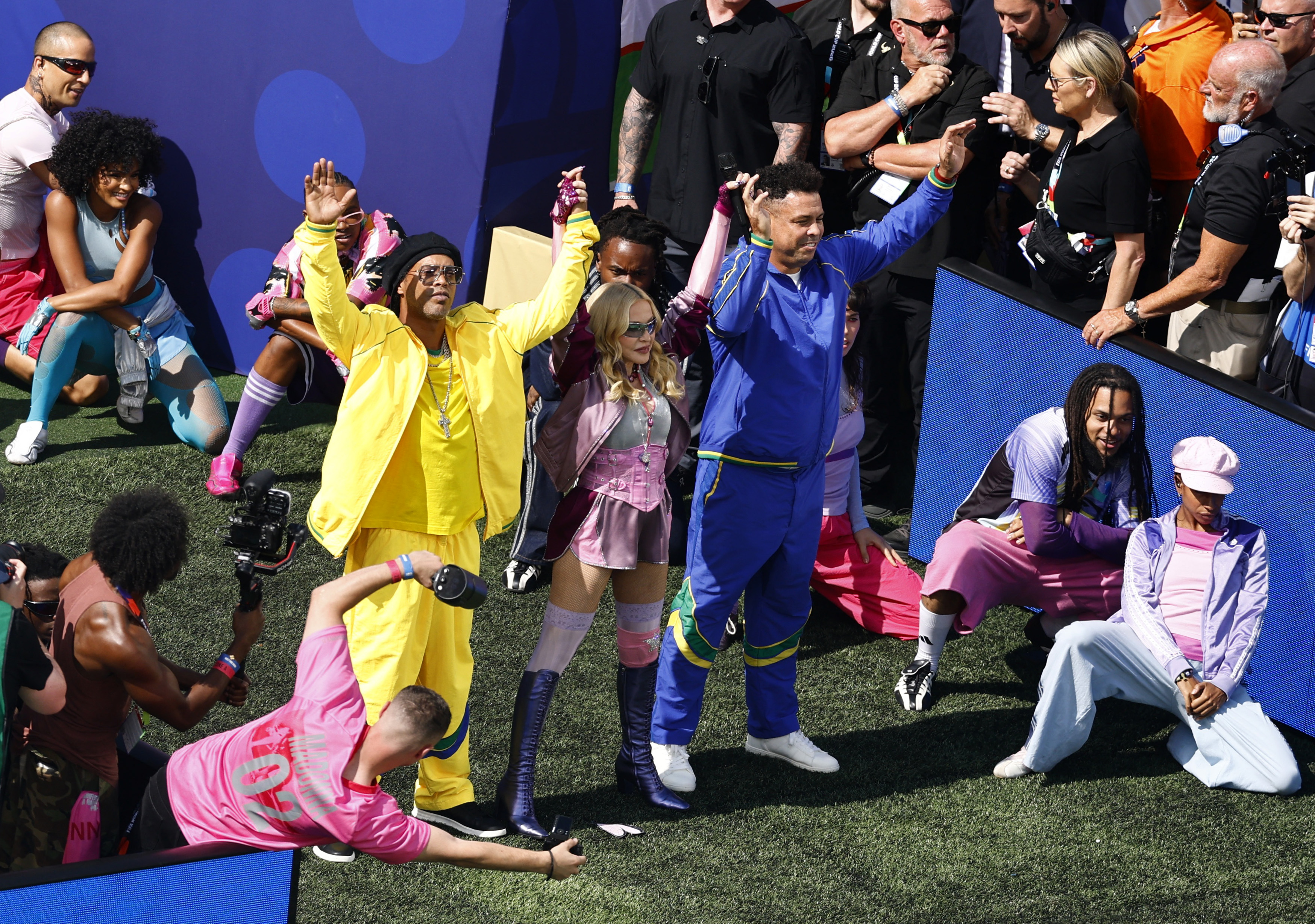Madonna, Ronaldinho, and Ronaldo performing together on stage at the FIFA World Cup 2026 final halftime show at MetLife Stadium