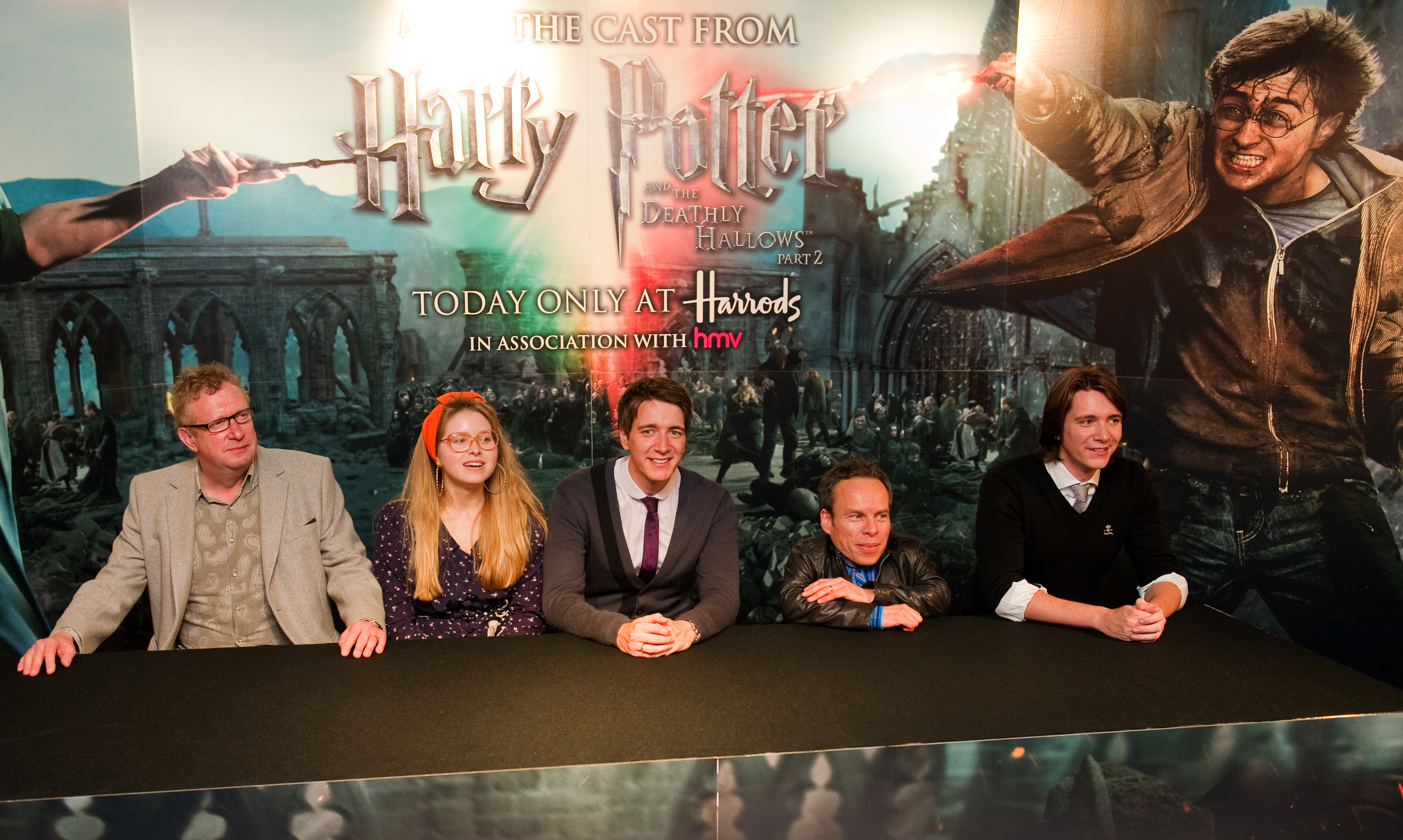Jessie Cave and Harry Potter cast members posing together at a Harrods promotional event in London in 2011