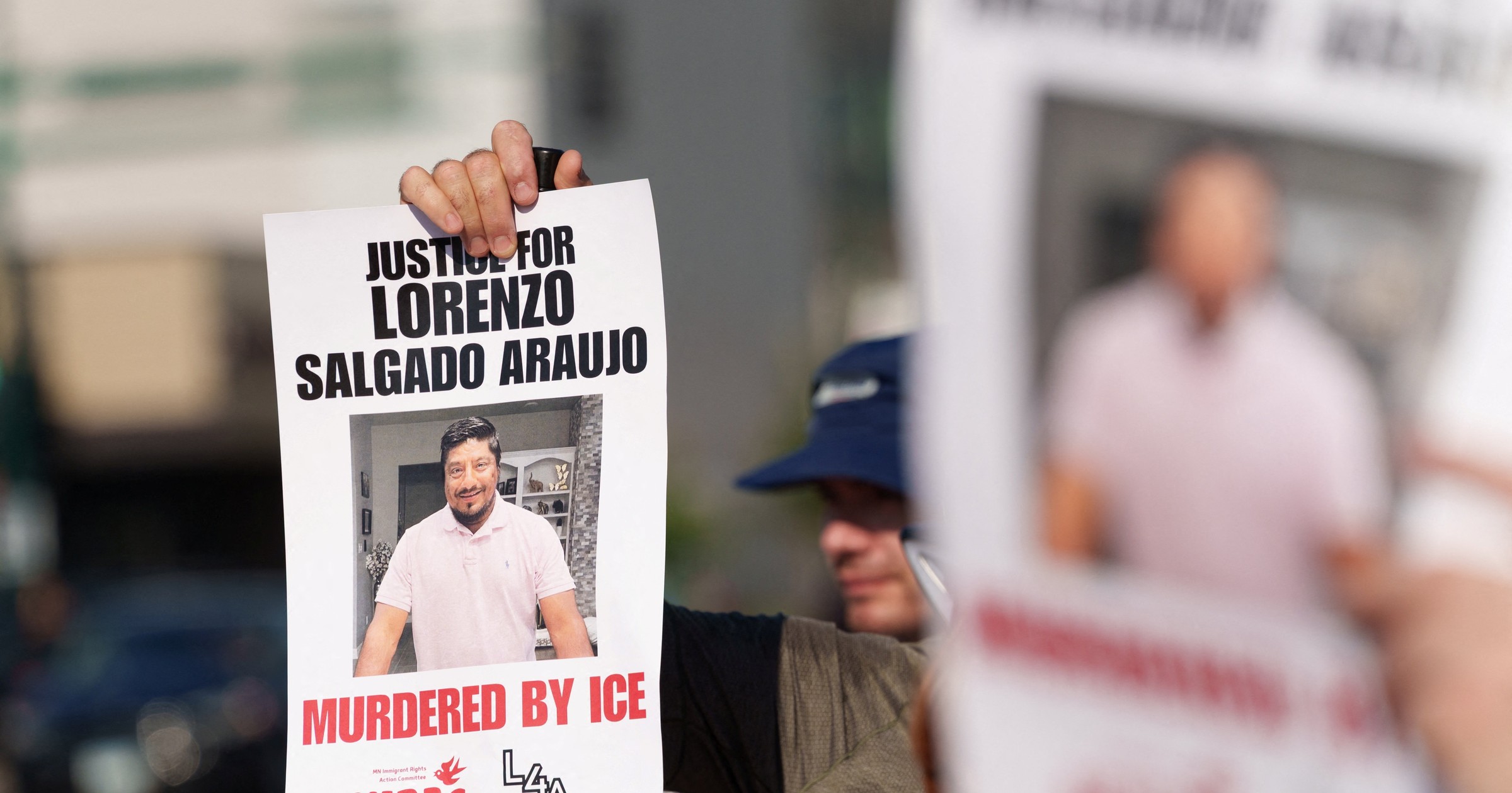 Crowd of protesters at a rally in Minneapolis holding signs against ICE following the deaths of two men shot by ICE agents