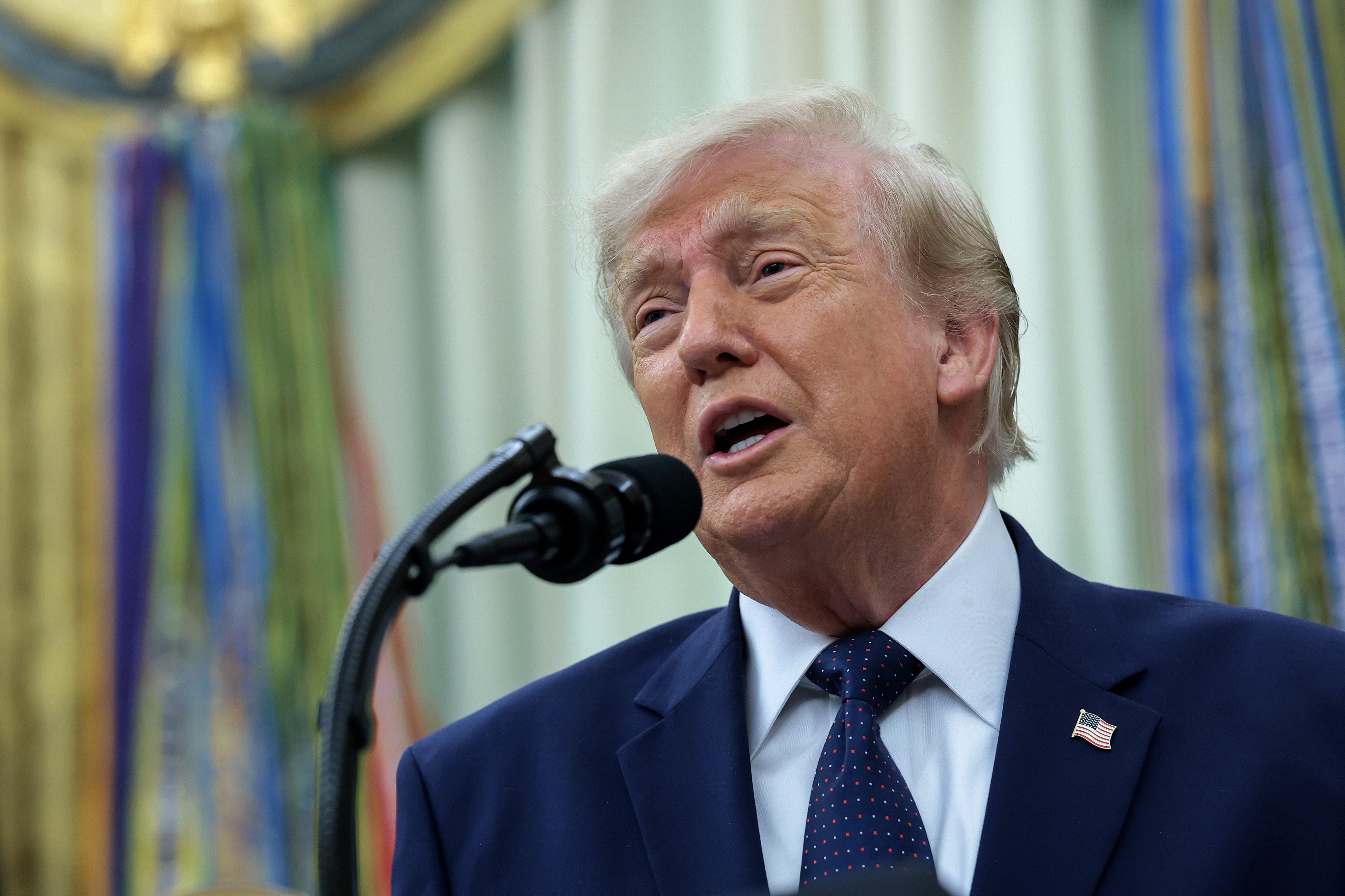 President Donald Trump speaking at the Resolute Desk in the Oval Office at the White House