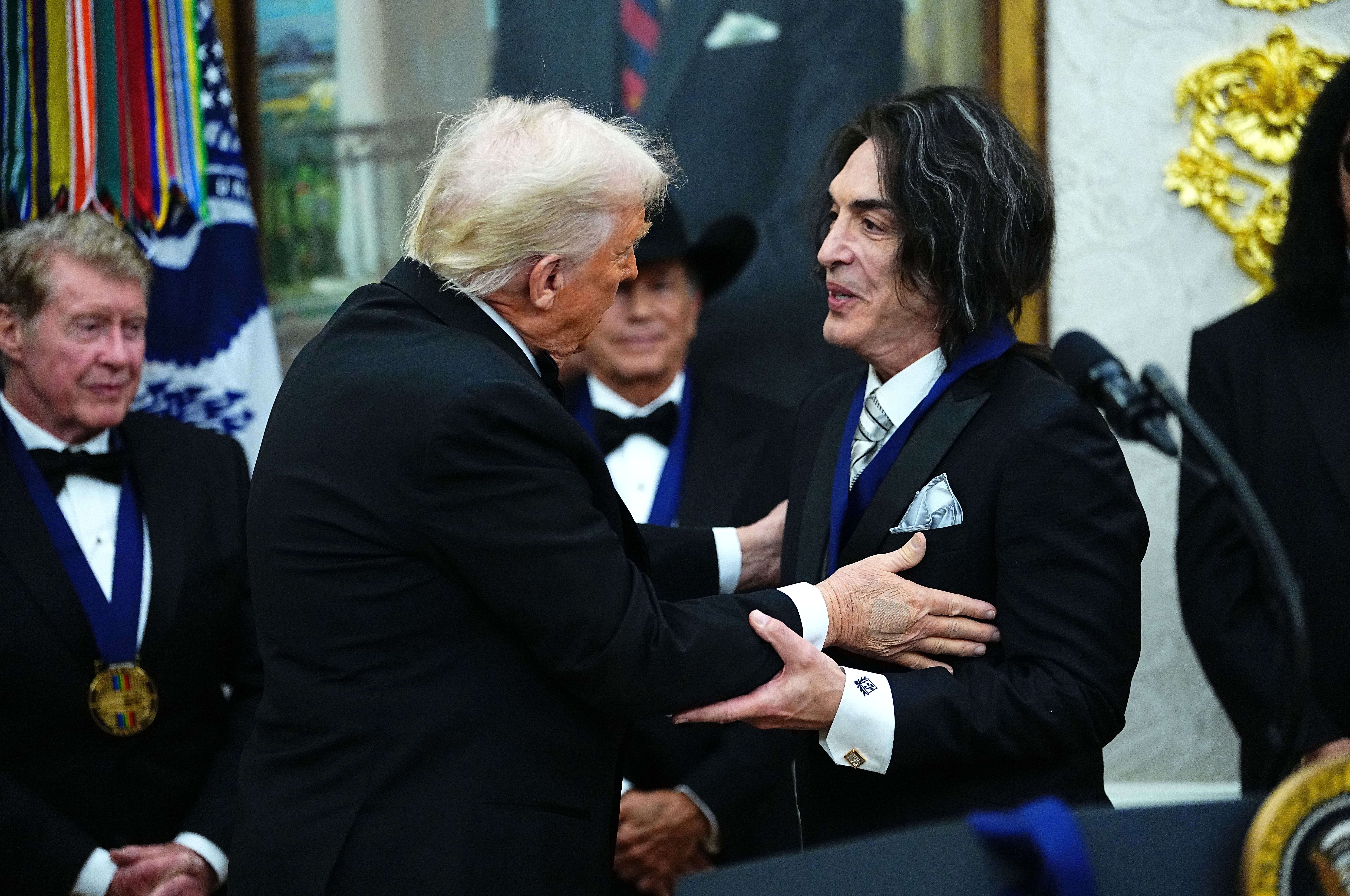 President Trump presenting Paul Stanley of KISS with a Kennedy Center Honors medal in the Oval Office