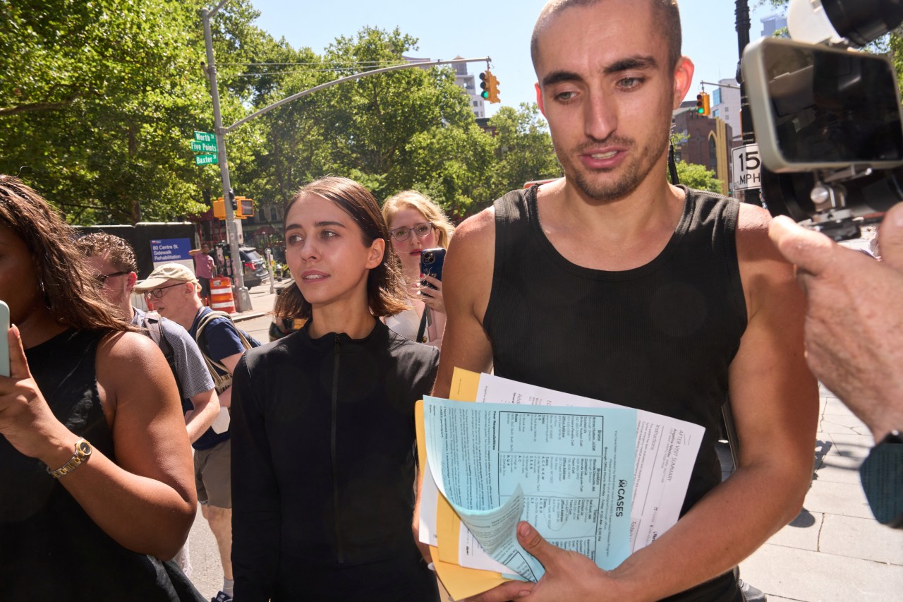 Angela Nikolau and Ivan Beerkus walking out of New York City Criminal Court after their arraignment