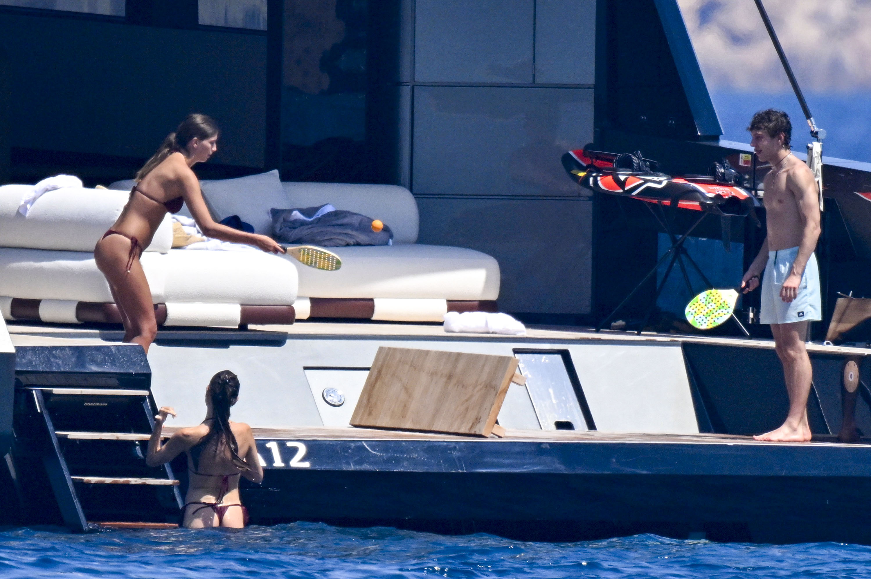 Kimi Antonelli on a yacht off the coast of Sardinia with his father and a young woman