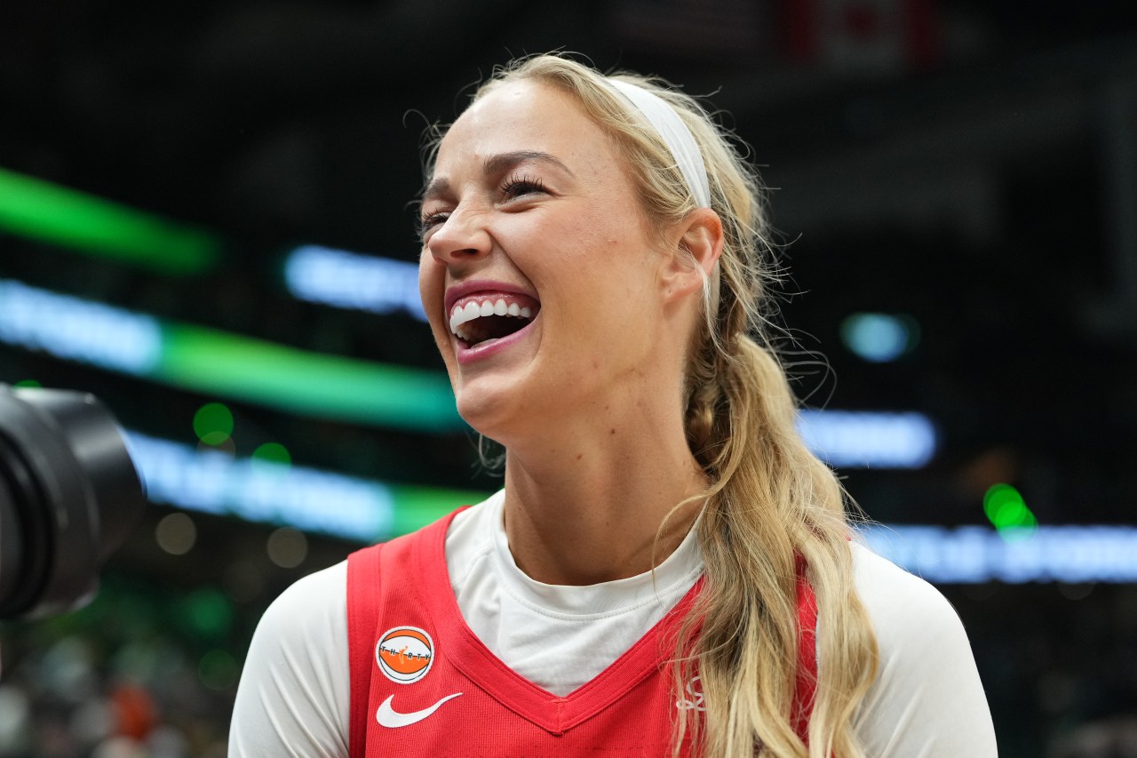 Sophie Cunningham in an Indiana Fever uniform smiling after a win against the Seattle Storm