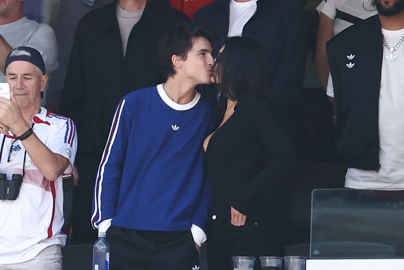 Click to open the image gallery Timothée Chalamet kissing Kylie Jenner in a stadium suite, with Marc Chalamet standing nearby