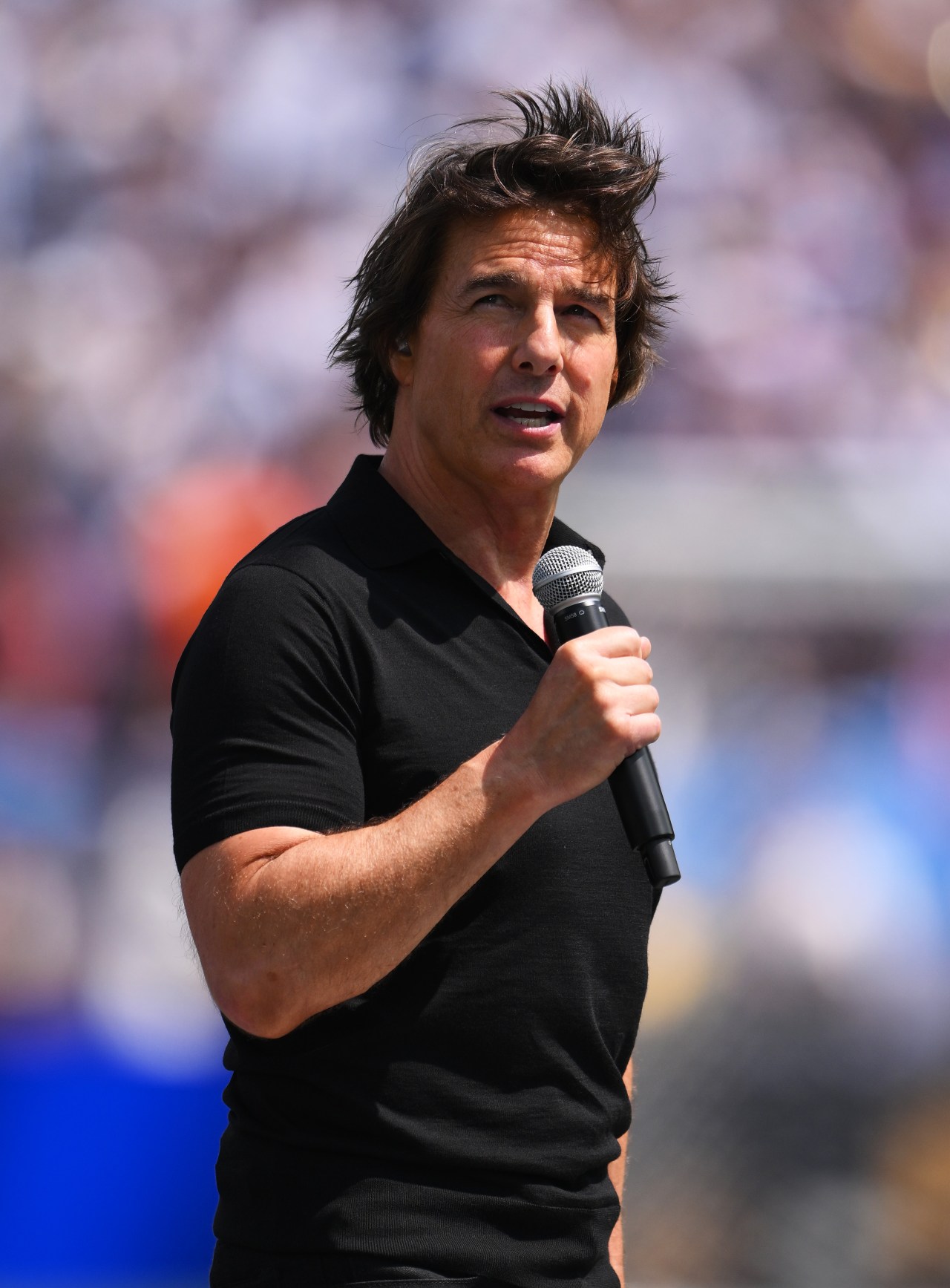 Tom Cruise speaking at a podium or on the field at New York New Jersey Stadium before the FIFA World Cup 2026 Final