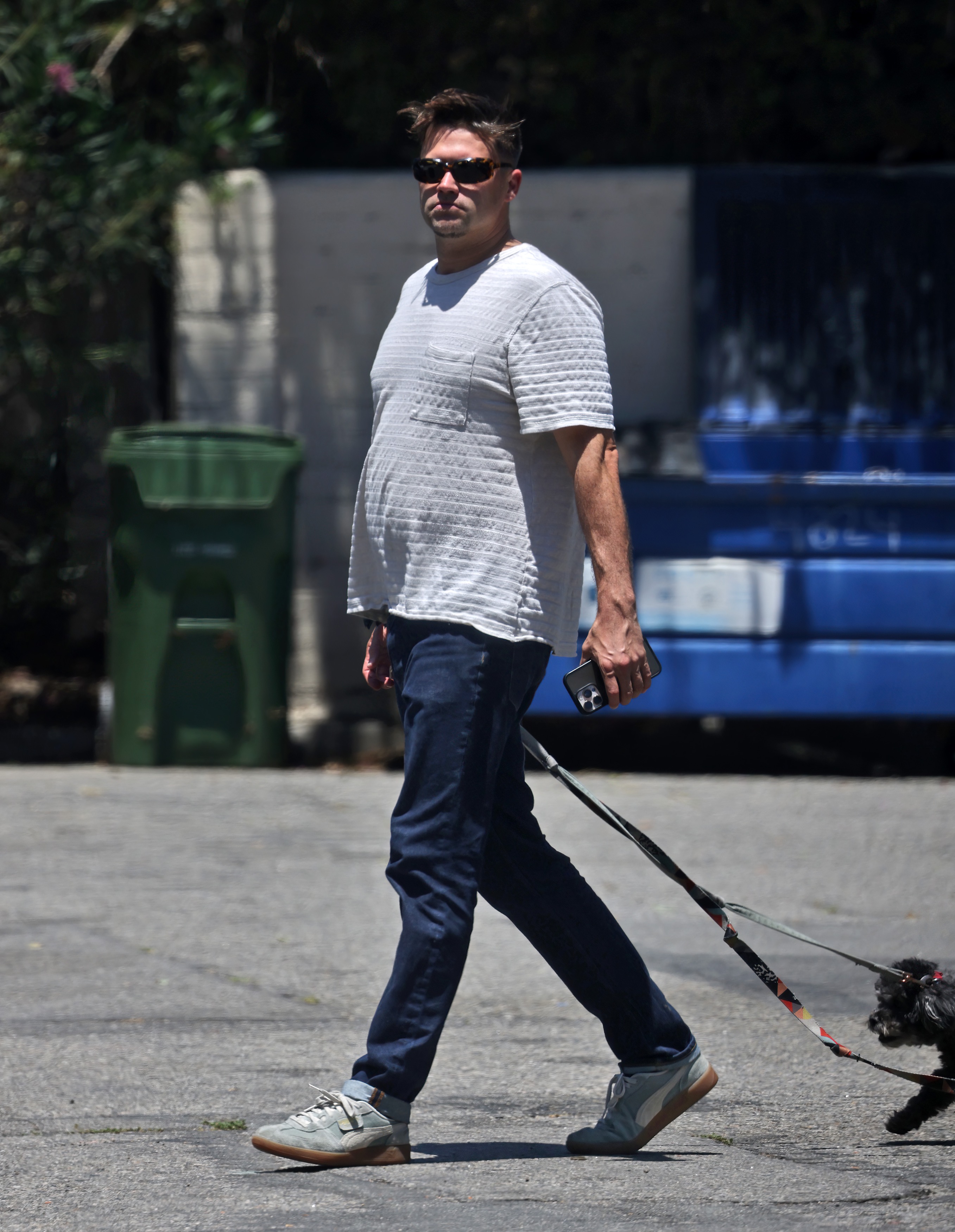 Tom Schwartz walking his dogs on a street in Los Angeles