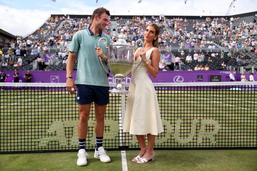 Tommy Paul and Paige Lorenze posing together with the cinch Championships 2024 winners trophy at The Queen's Club in London