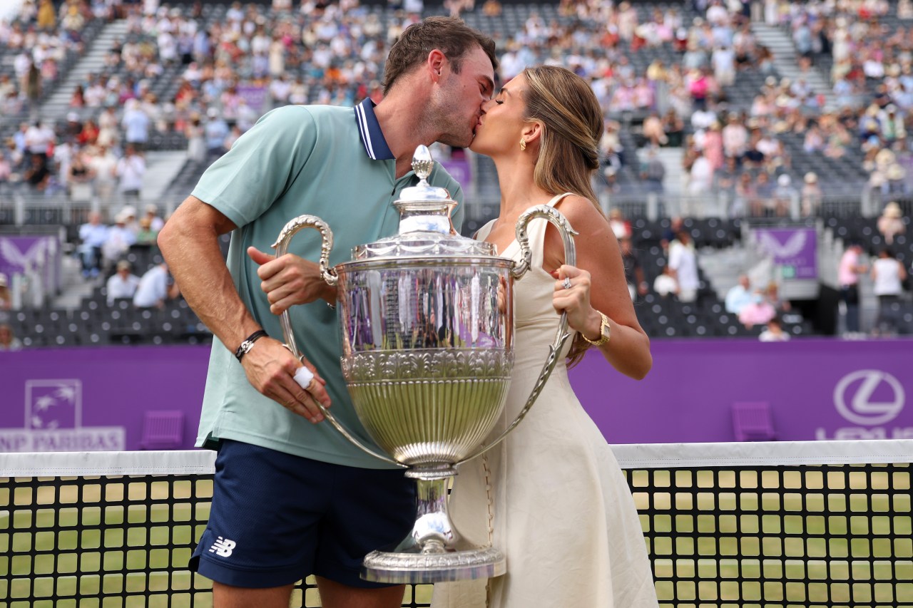 Tommy Paul and Paige Lorenze posing together with the cinch Championships 2024 winners trophy at The Queen's Club in London