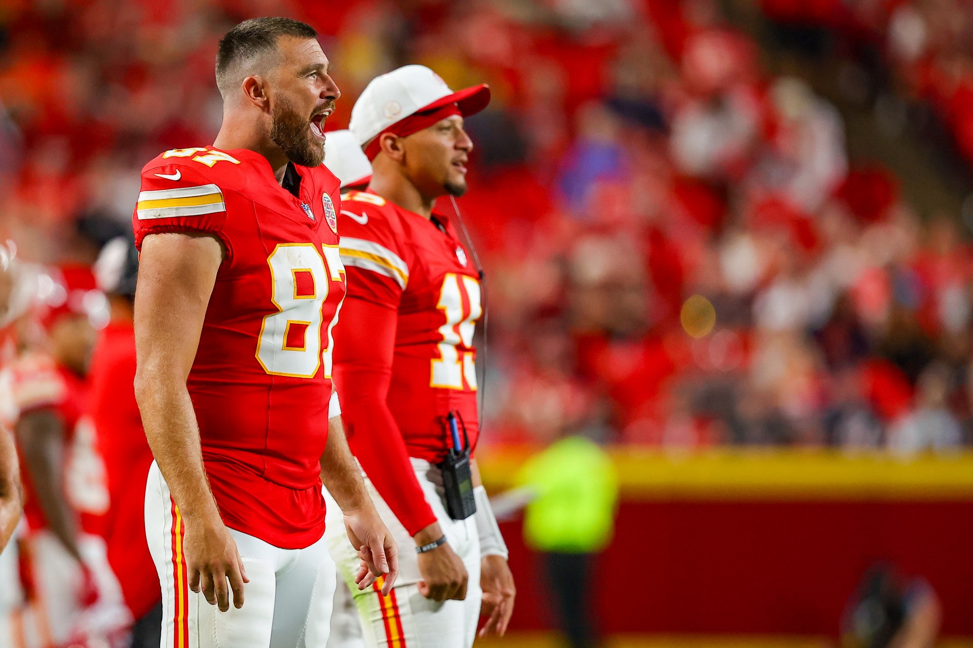 Travis Kelce #87 and Patrick Mahomes #15 of the Kansas City Chiefs watching game action at Arrowhead Stadium during a 2025 NFL preseason game