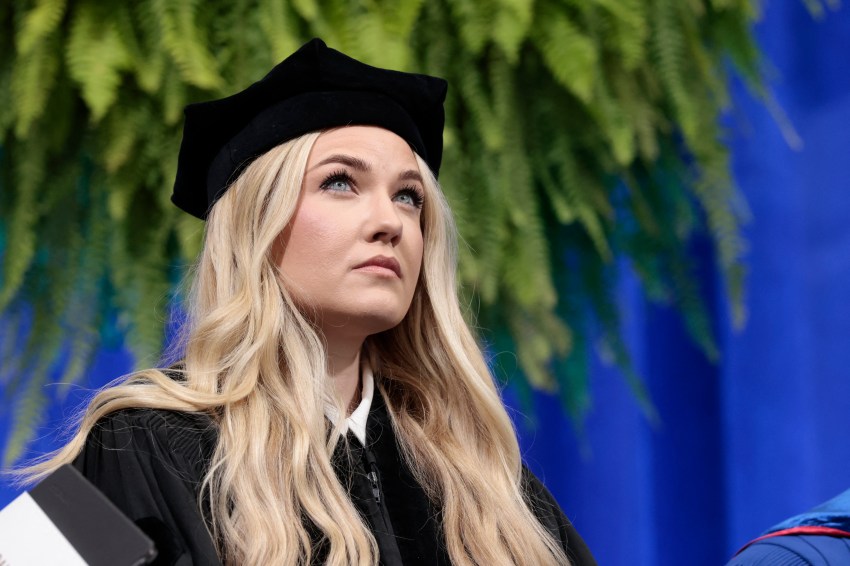 Erika Kirk speaking at a podium during Hillsdale College's commencement ceremony
