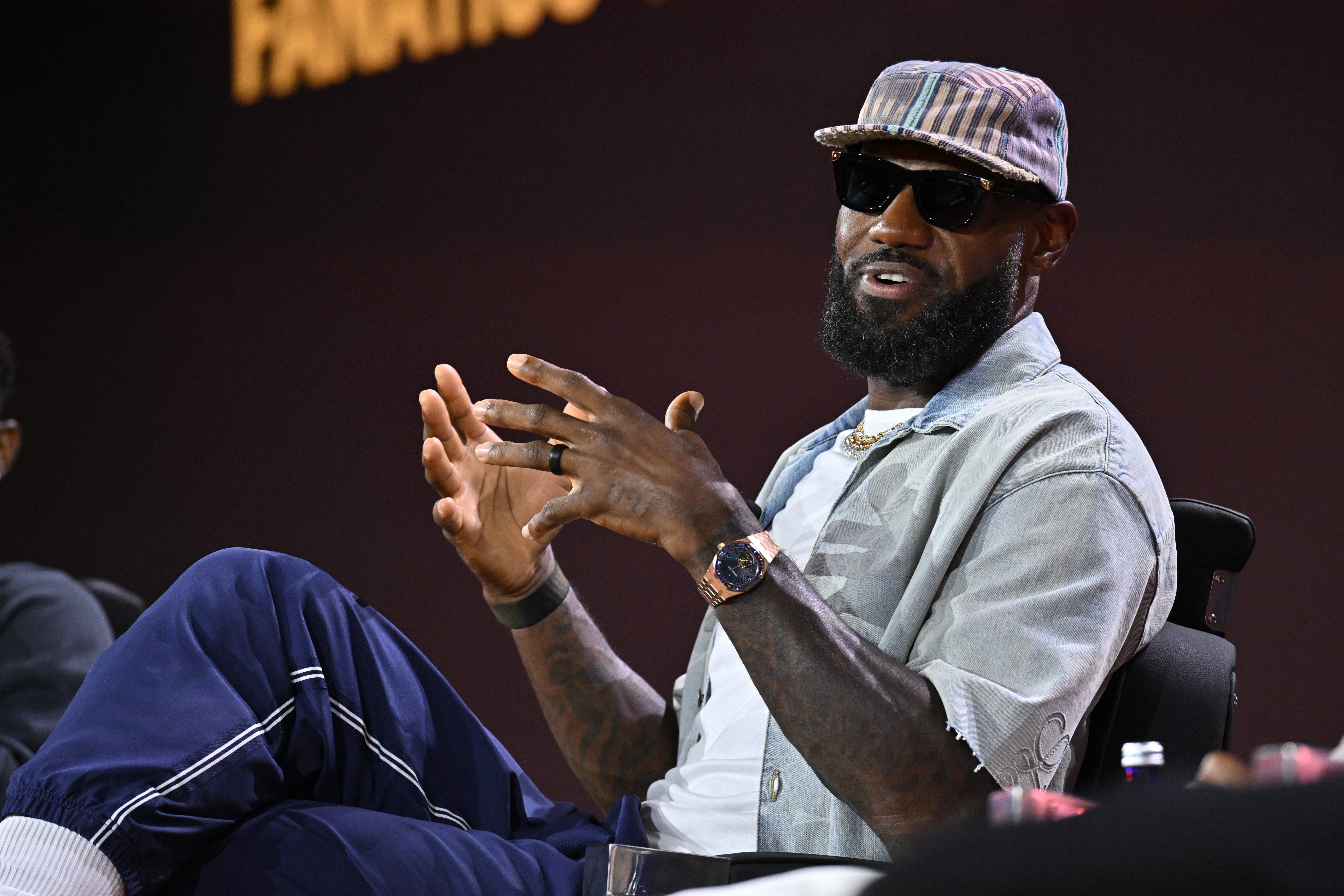 LeBron James speaking onstage at a panel event at Jacob Javits Center in New York City