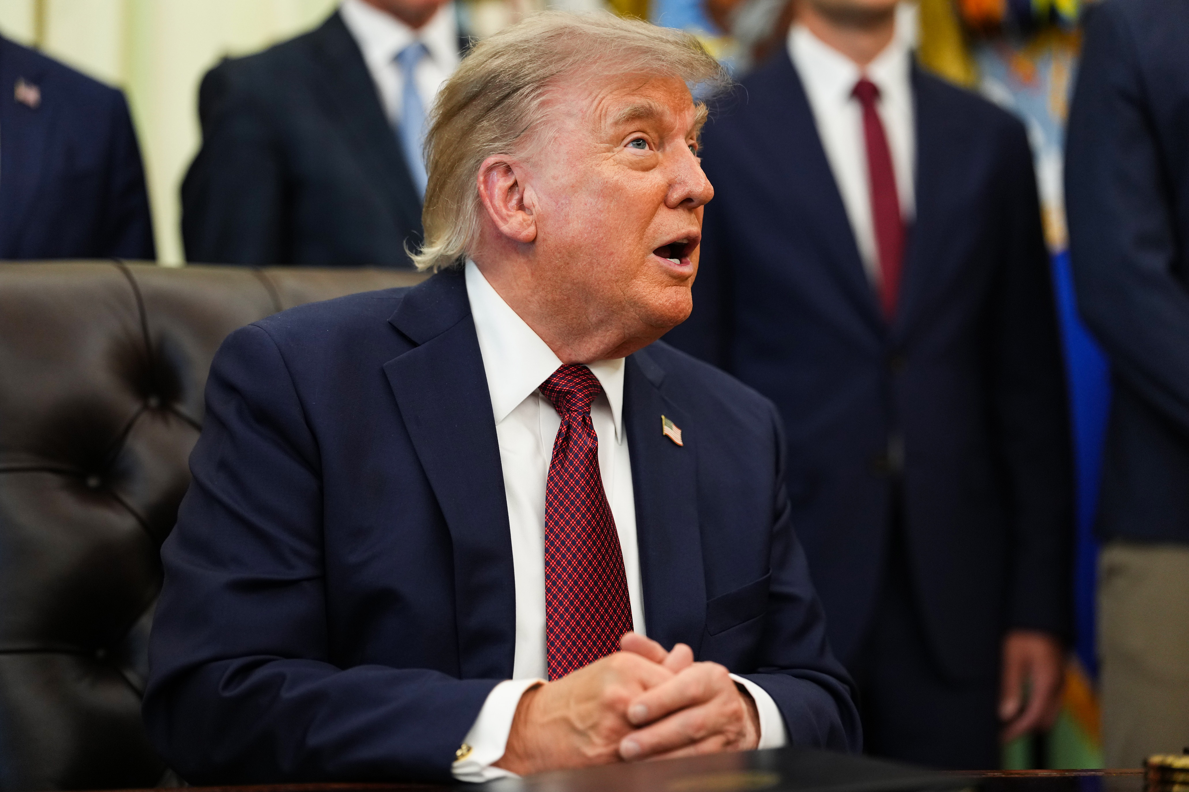 President Donald Trump speaking at a desk in the Oval Office at the White House