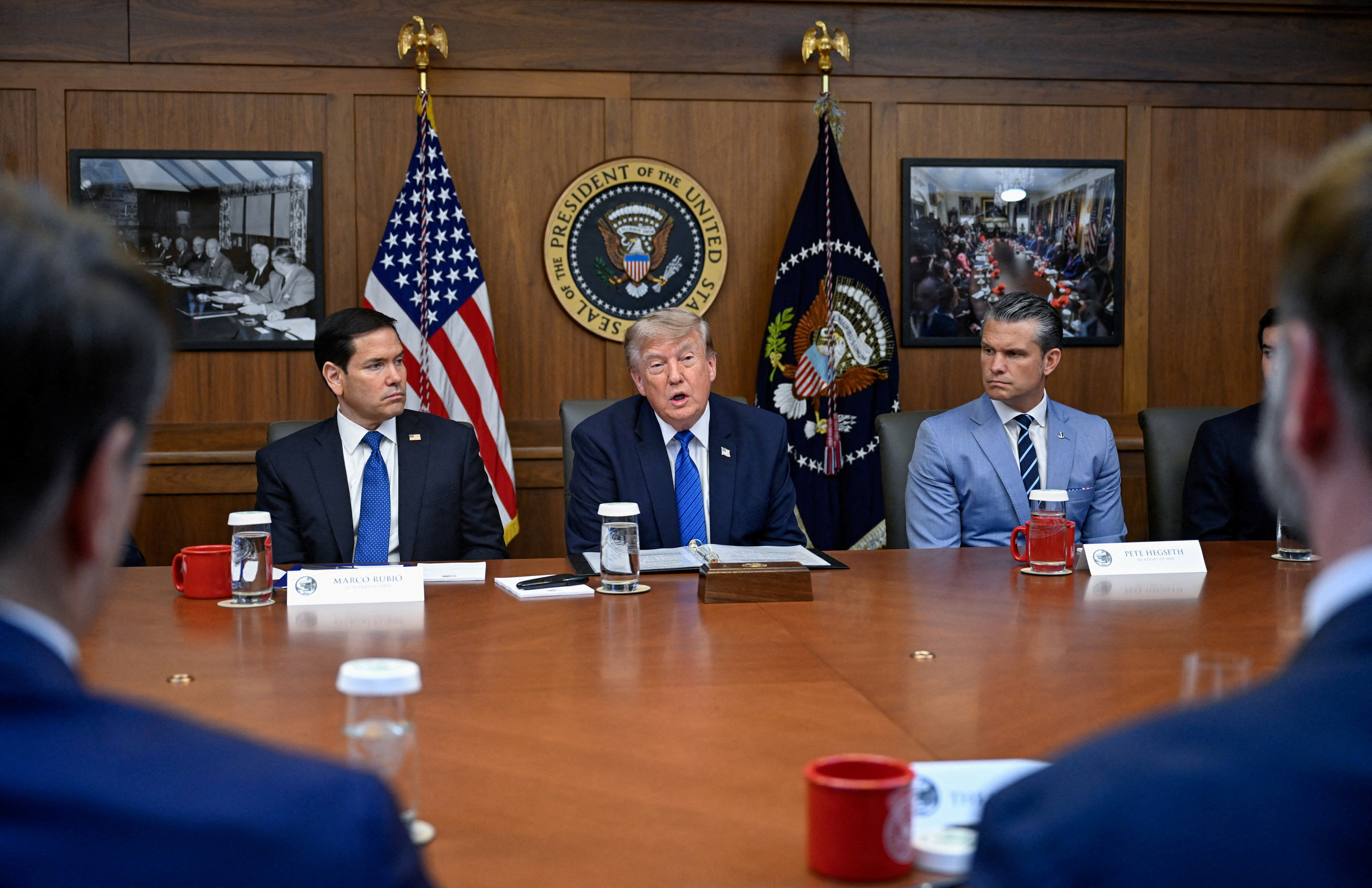 Donald Trump, Marco Rubio, Pete Hegseth, JD Vance, and Todd Blanche seated at a cabinet meeting table at Camp David