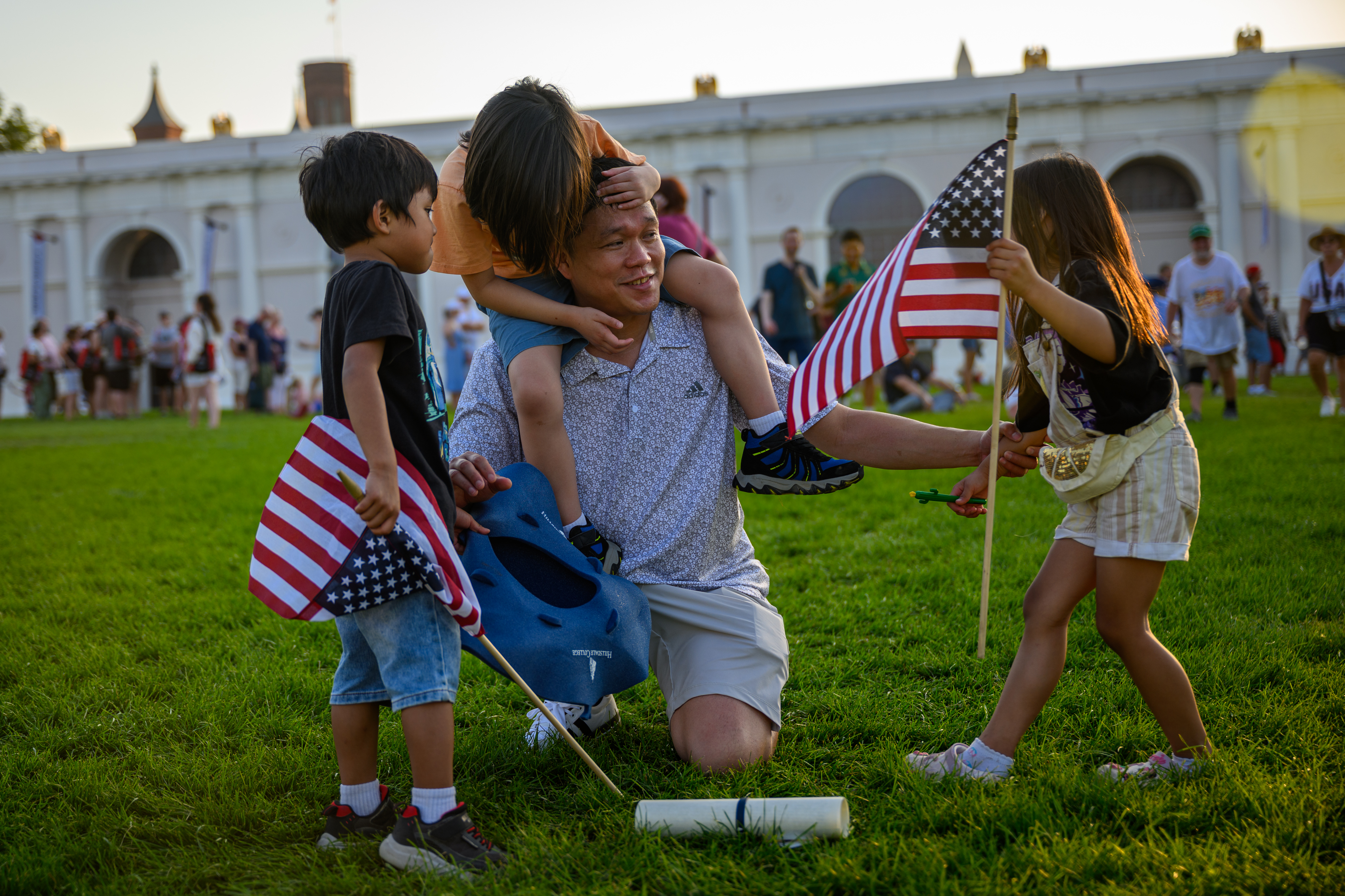 A man and his three young kids at the Great American State Fair in Washington, D.C.