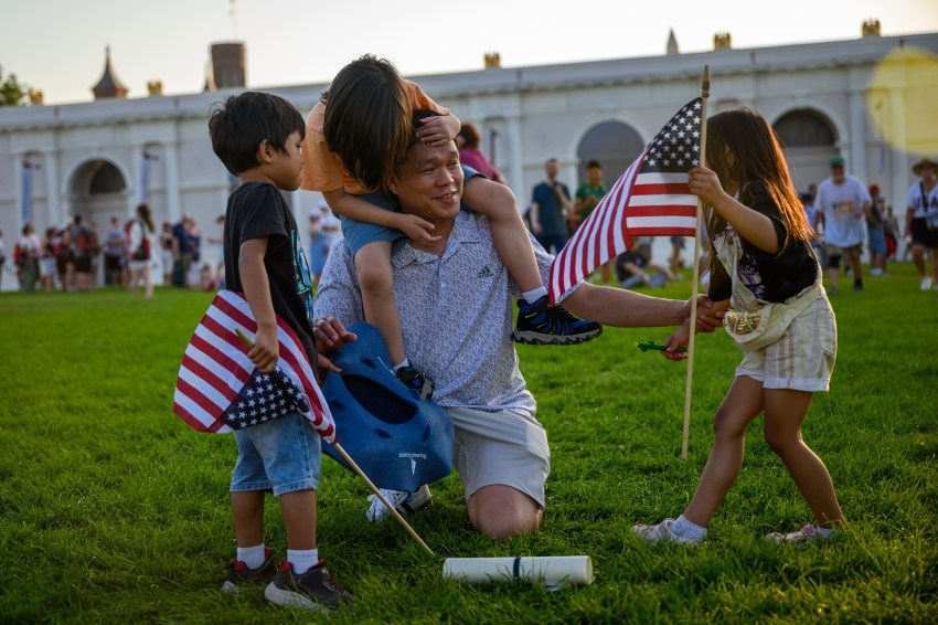 A man and his three young kids at the Great American State Fair in Washington, D.C.