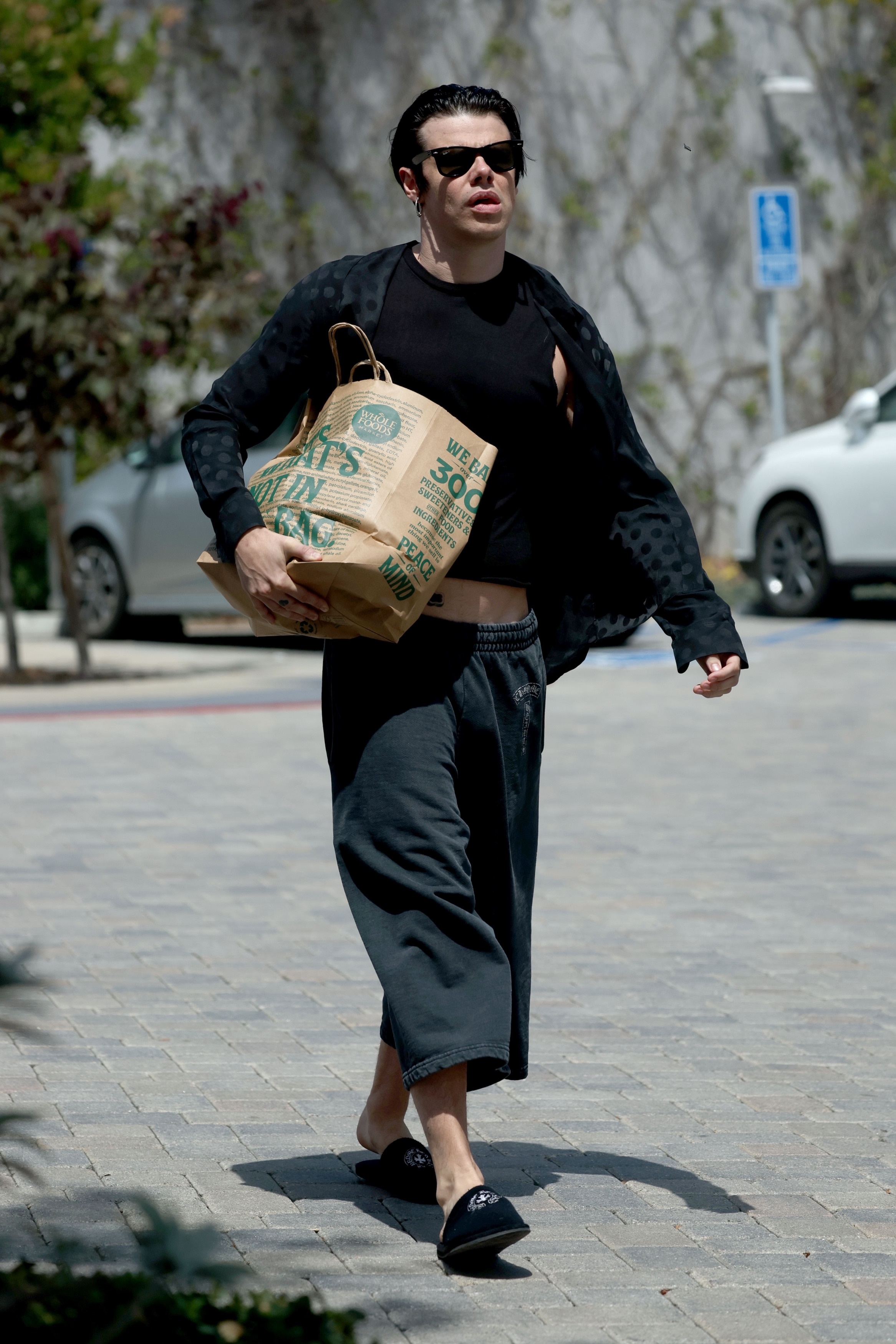 Yungblud carrying a Whole Foods grocery bag next to a Can-Am Defender vehicle in Malibu