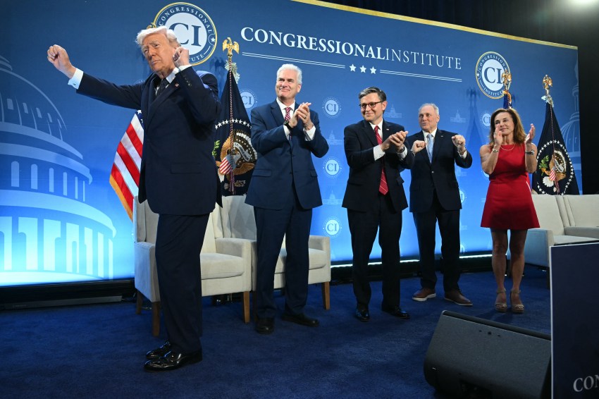 President Trump spreads his arms dancing on stage while four House Republican leaders clap behind him at the Congressional Institute event at Trump National Doral.