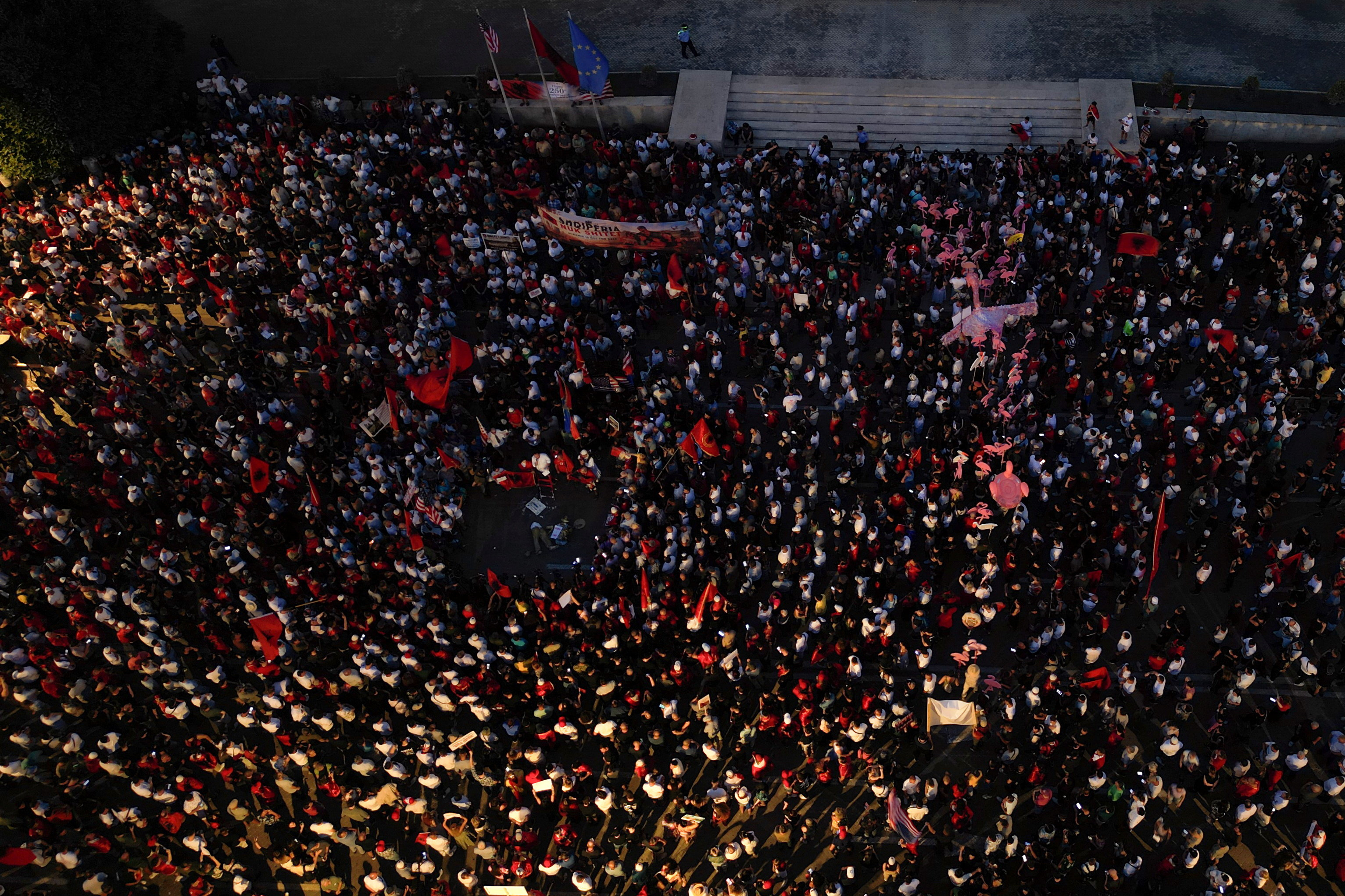 Aerial view of protesters waving Albanian national flags in Tirana during a demonstration against a planned luxury resort linked to Jared Kushner