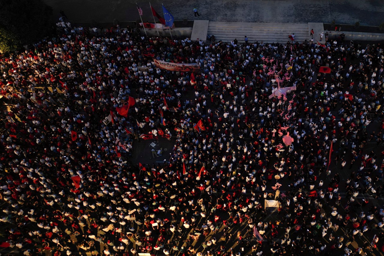 Aerial view of protesters waving Albanian national flags in Tirana during a demonstration against a planned luxury resort linked to Jared Kushner