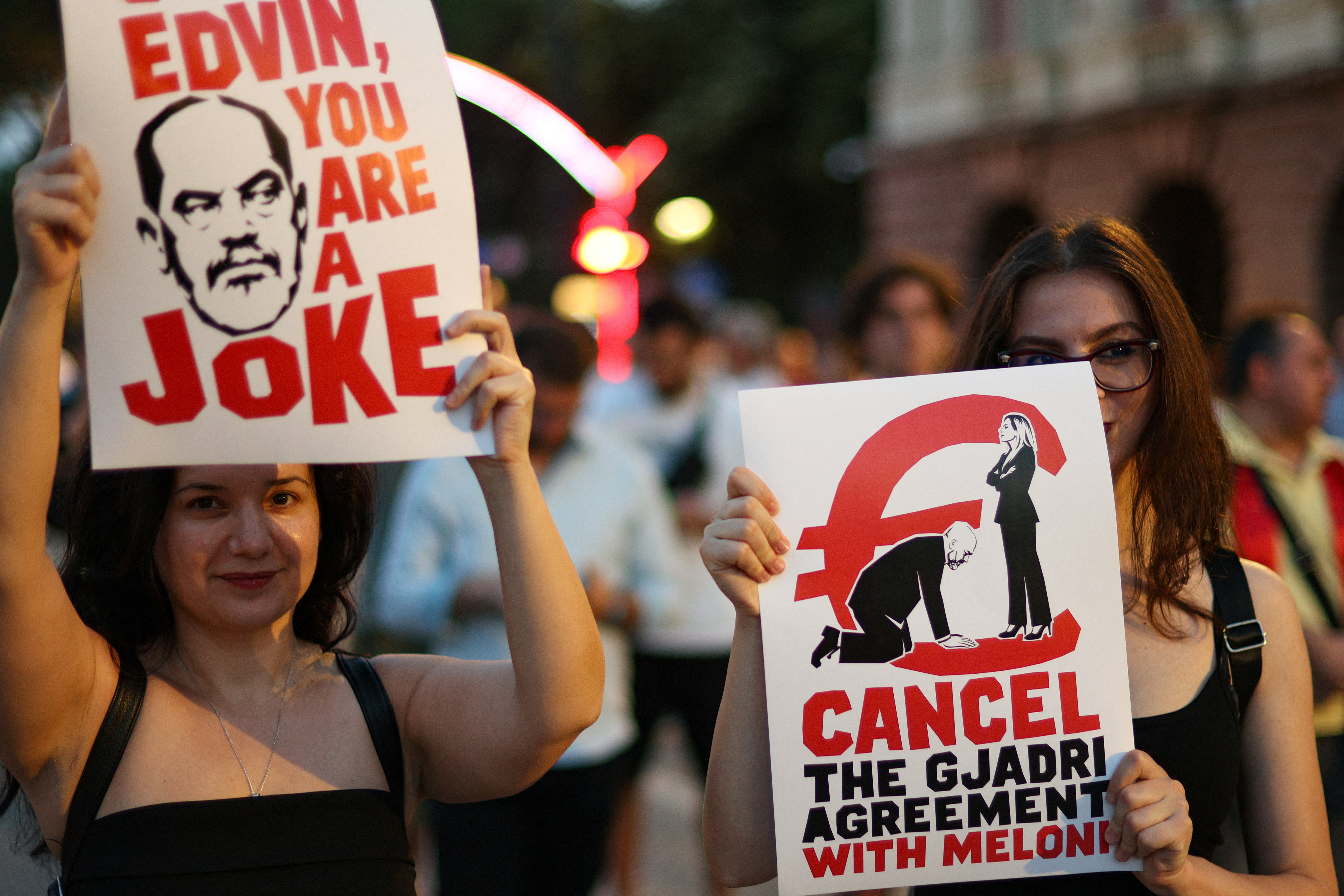 Protesters holding placards in Tirana, Albania, demonstrating against a planned luxury resort linked to Jared Kushner