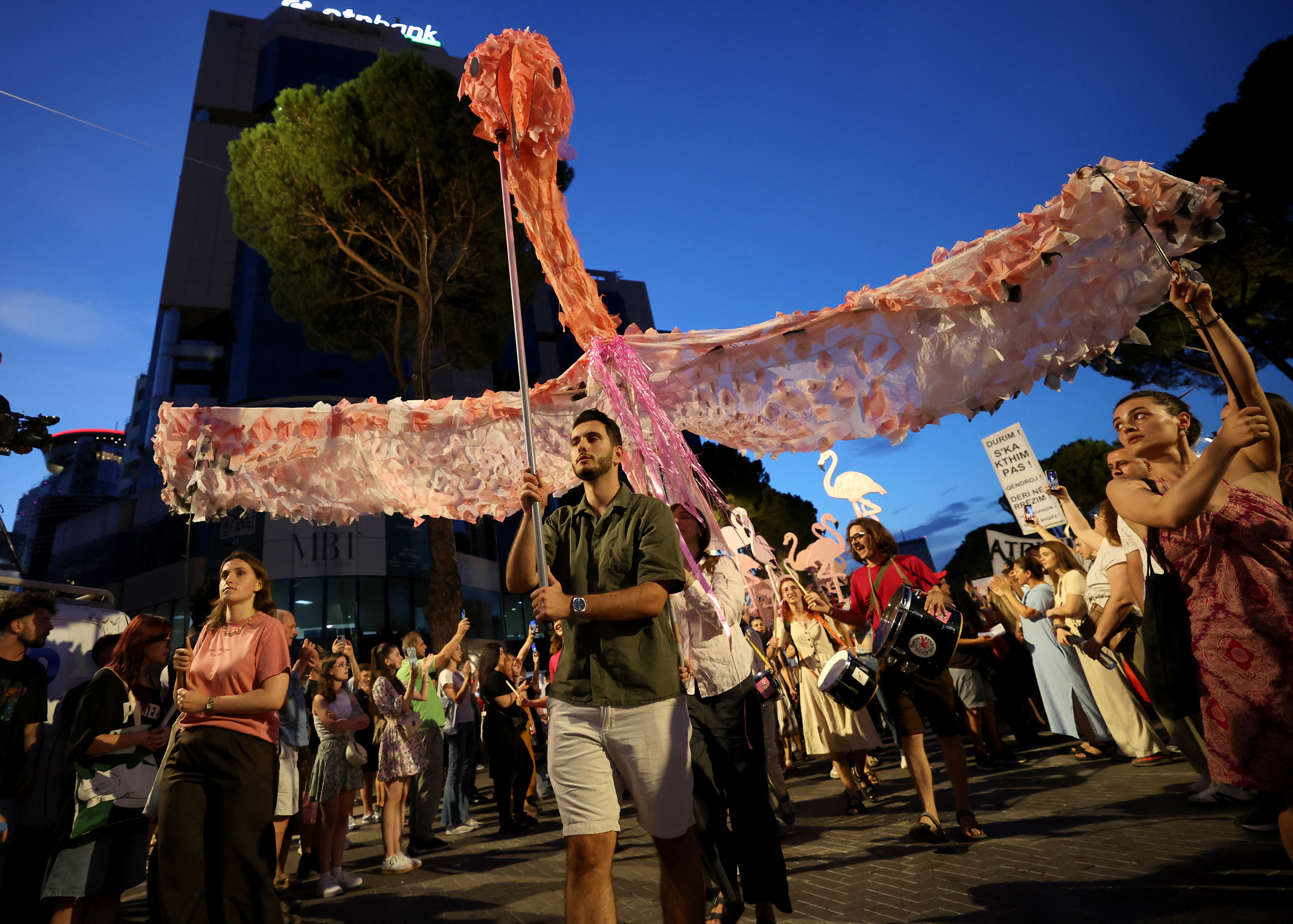 Protesters carrying a large flamingo sculpture outside the Albanian Prime Minister's Office in Tirana