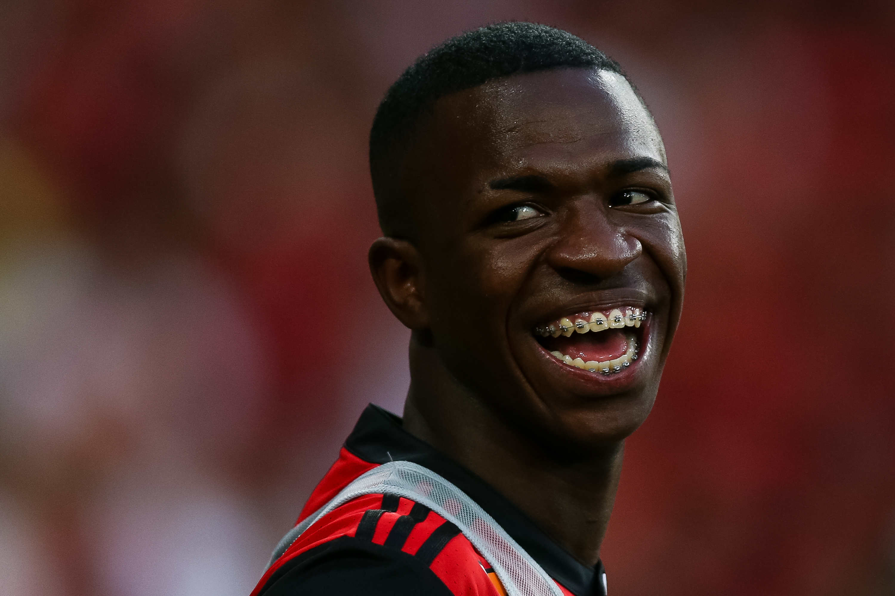 Vinícius Jr. smiling during a Flamengo vs. Atletico MG match at Maracanã Stadium in Rio de Janeiro