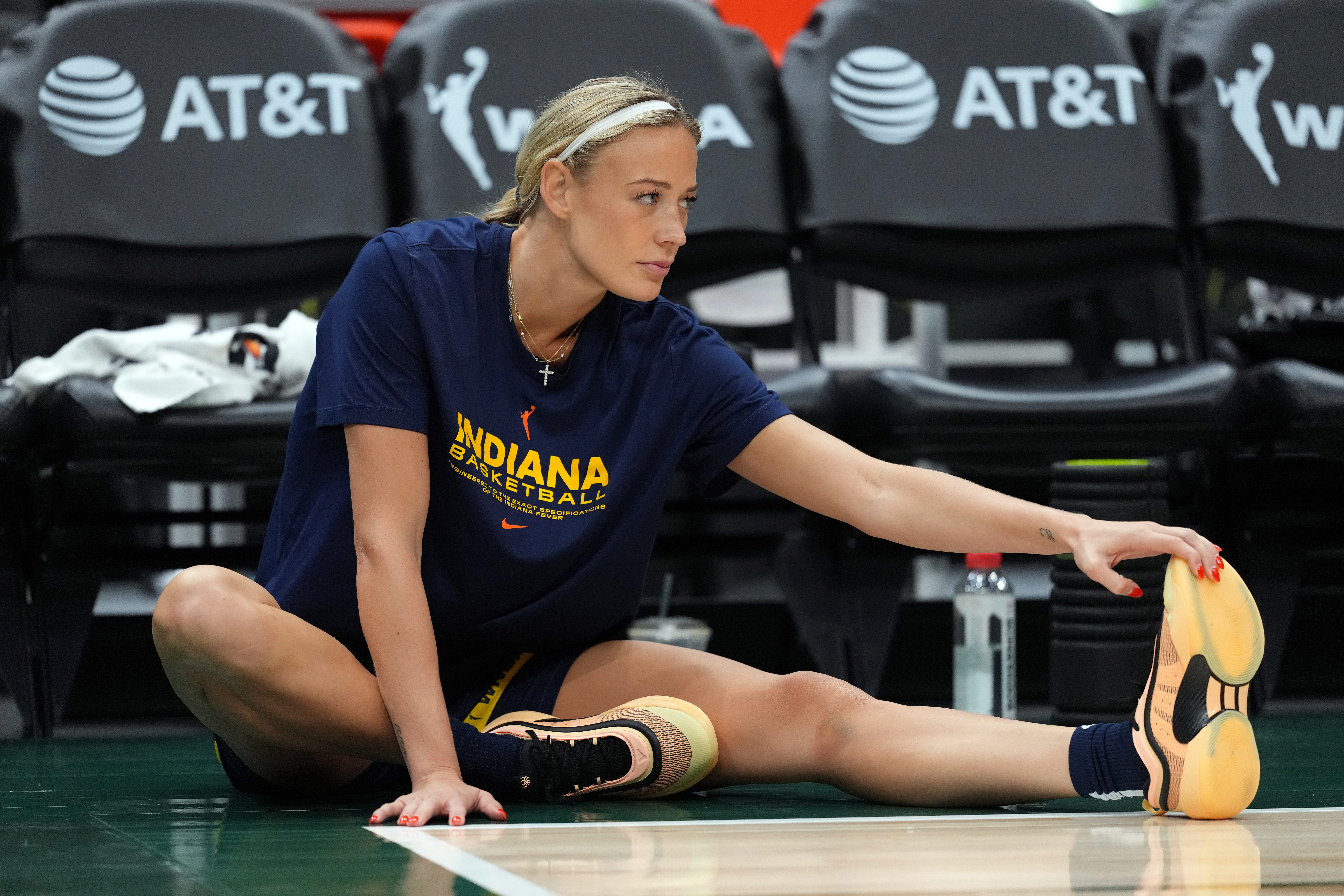 Sophie Cunningham in Indiana Fever uniform stretching before a game against the Seattle Storm