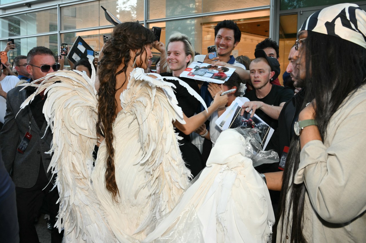 Zendaya signing autographs for fans at The Odyssey premiere at AMC Lincoln Square in New York