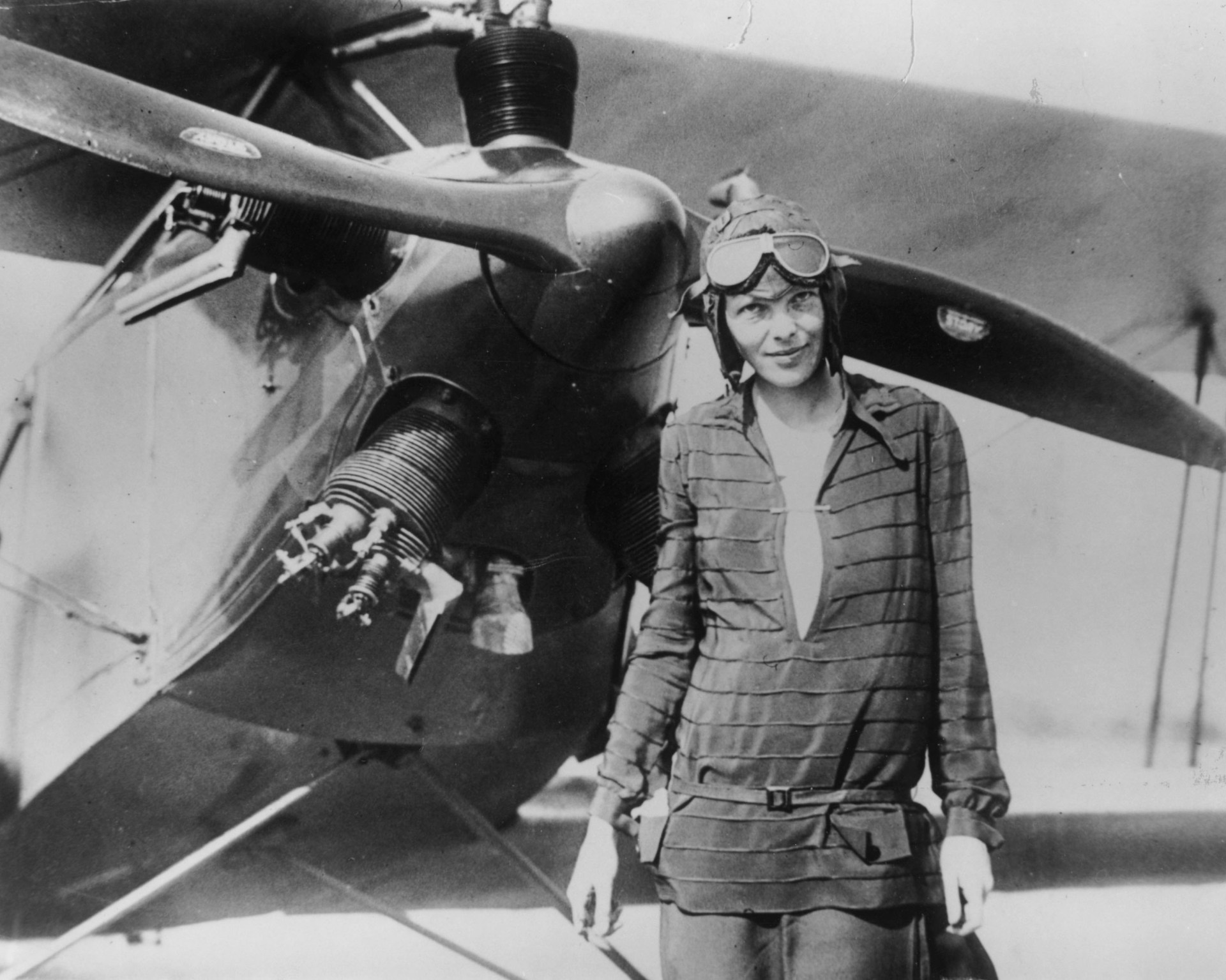 Amelia Earhart standing in front of her biplane called Friendship in Newfoundland in 1928