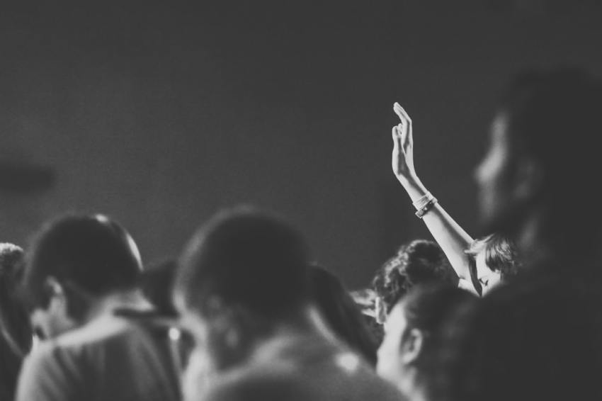Person raising their right hand