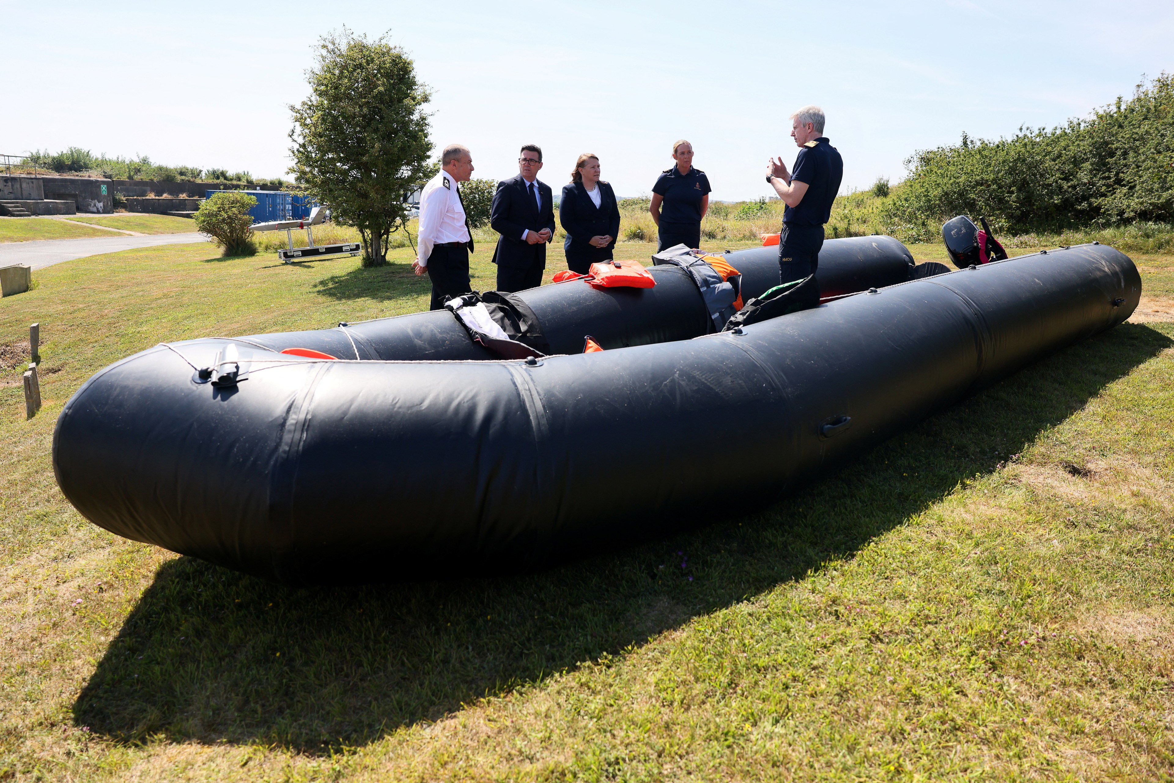 Prime Minister Andy Burnham and Anna Turley stand beside a small recovered migrant boat at HM Coastguard Maritime Rescue Coordination Centre in Dover