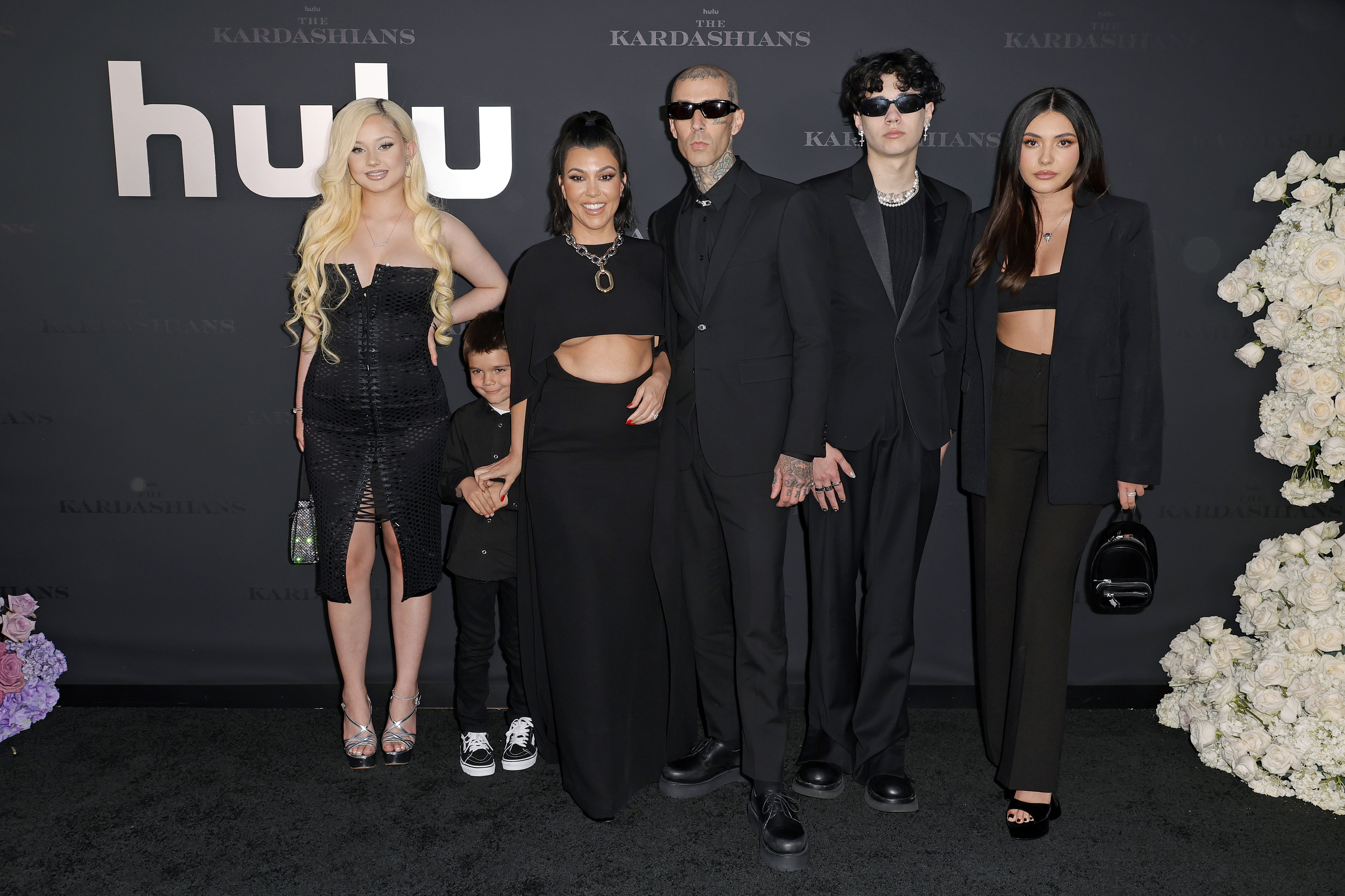 Alabama Barker, Reign Disick, Kourtney Kardashian, Travis Barker, Landon Barker, and Atiana De La Hoya posing together at a premiere event