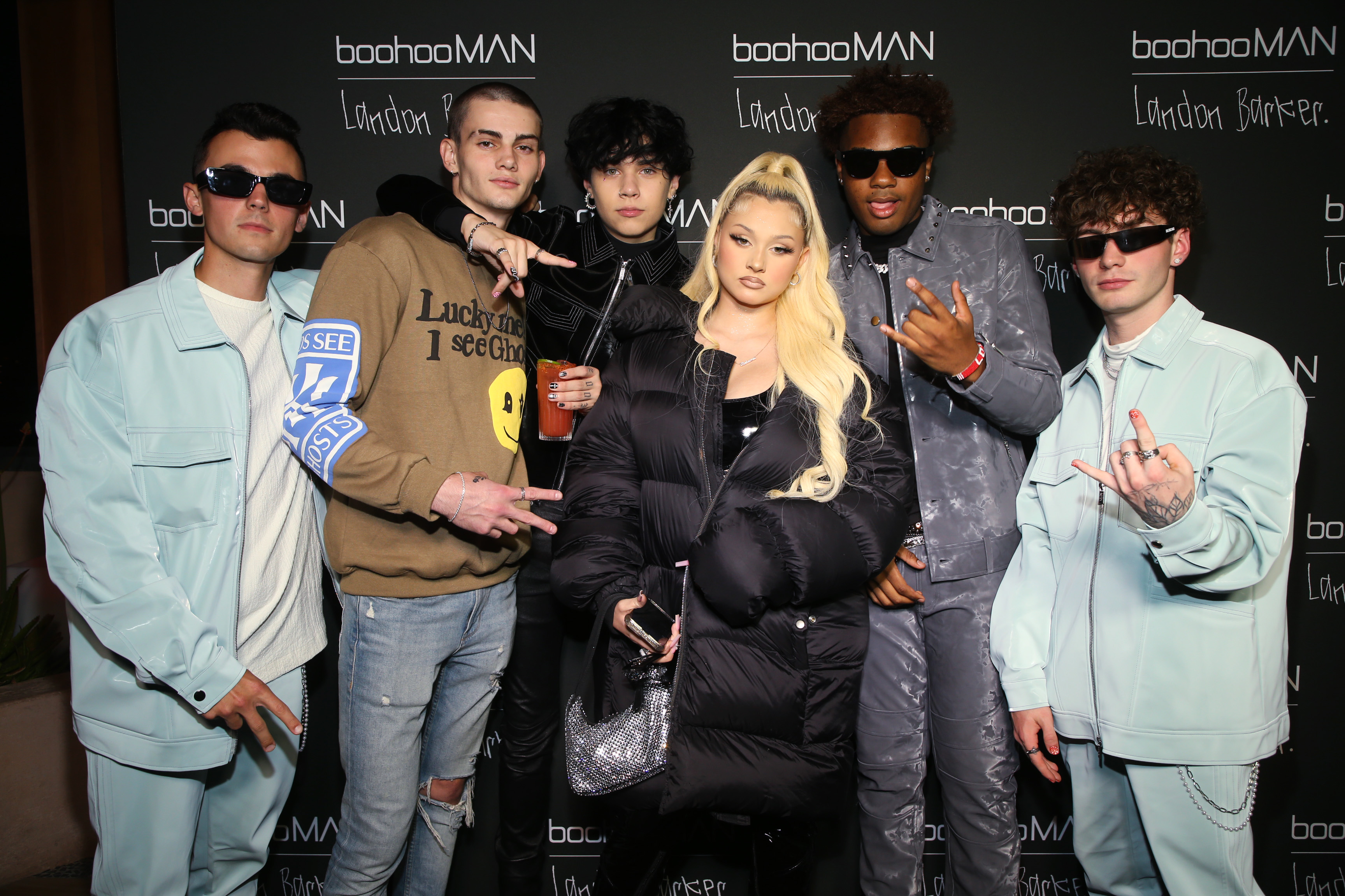 Alabama Barker and Landon Barker posing with friends at the boohooMAN x Landon Barker launch party in Los Angeles
