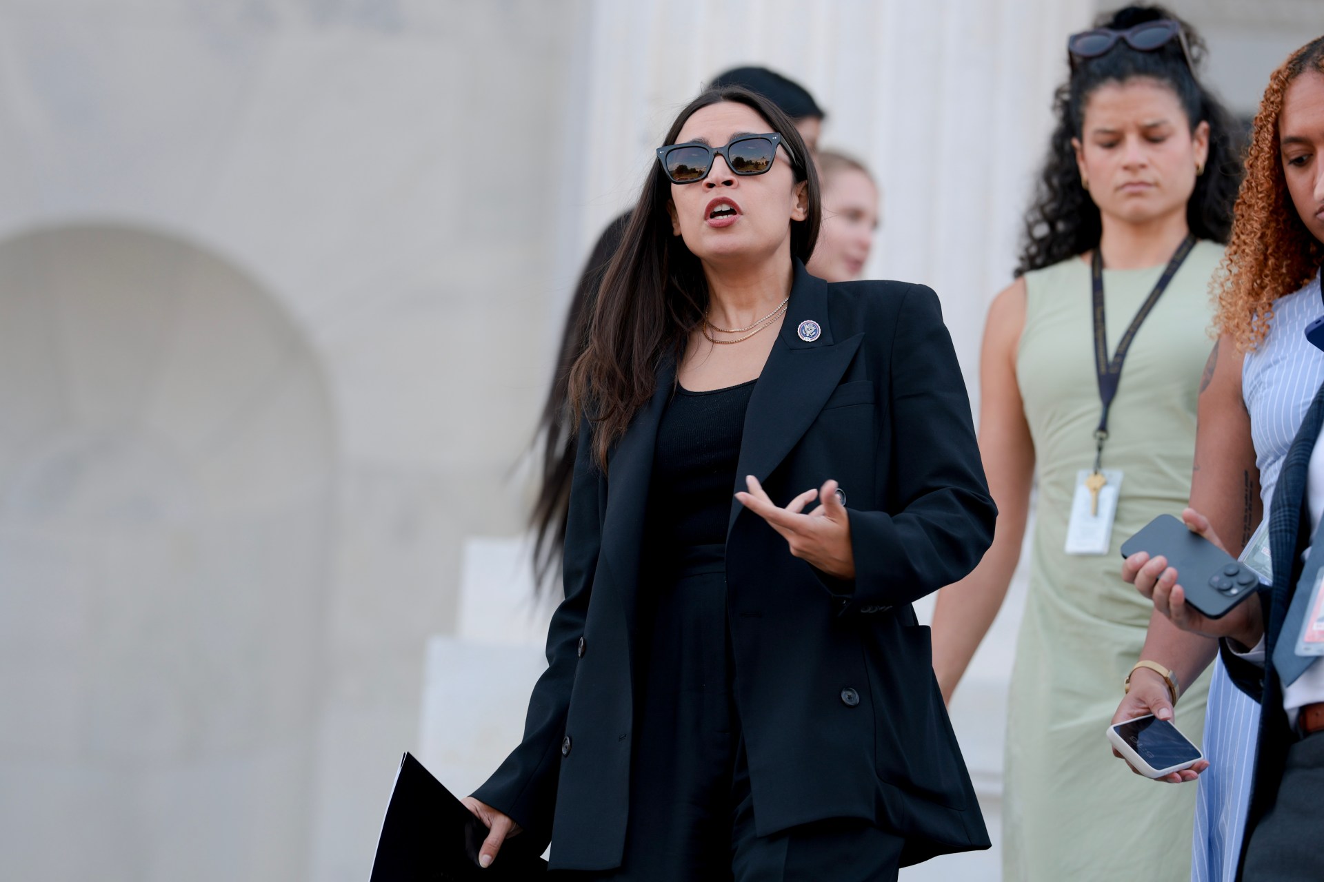 Alexandria Ocasio-Cortez speaking to reporters on the steps of the U.S. Capitol
